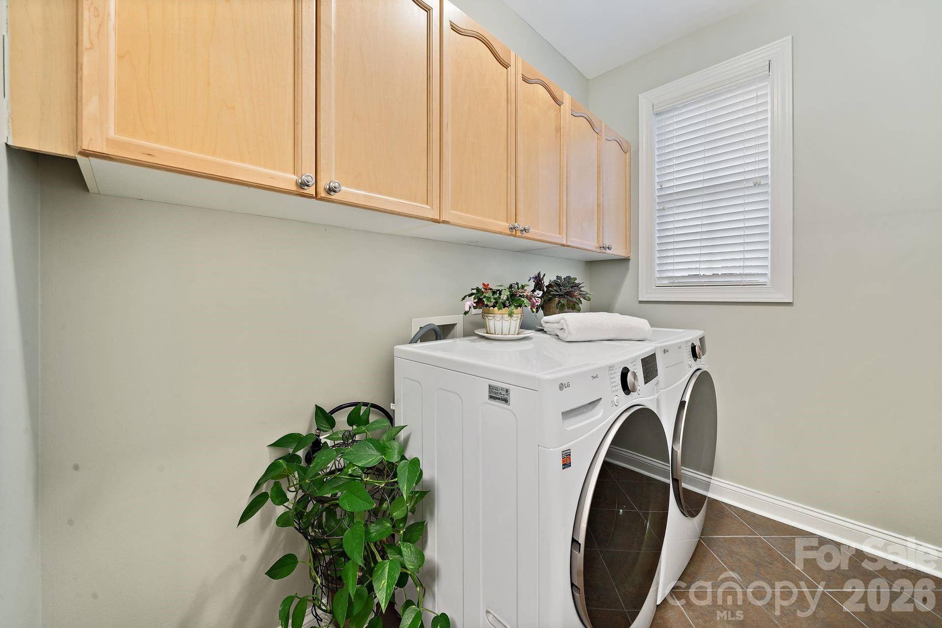 Laundry room on main level with storage