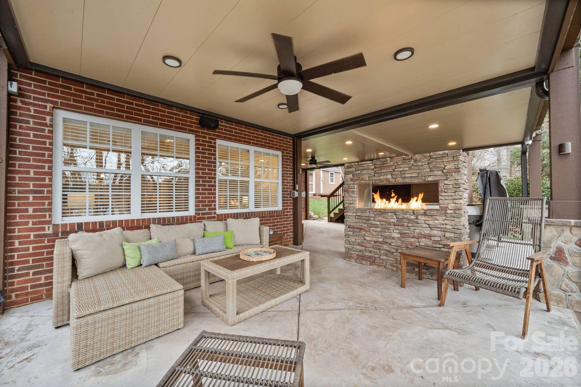 Double-sided gas fireplace with stone surround