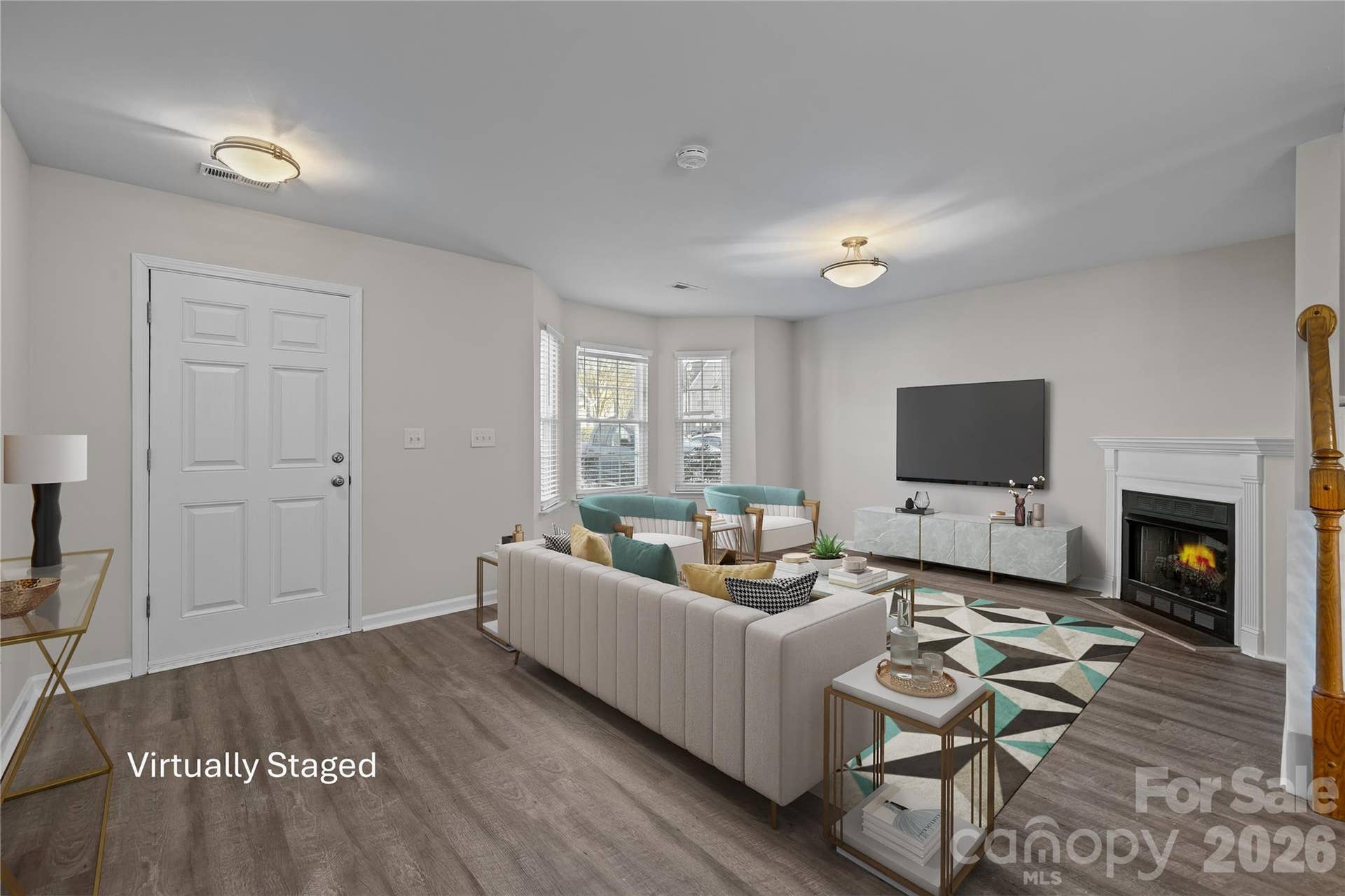 Welcoming living room with durable flooring, gas log fireplace with decorative mantel and generous wall space ideal for a large screen TV. Brand new light fixtures in entry and living room.