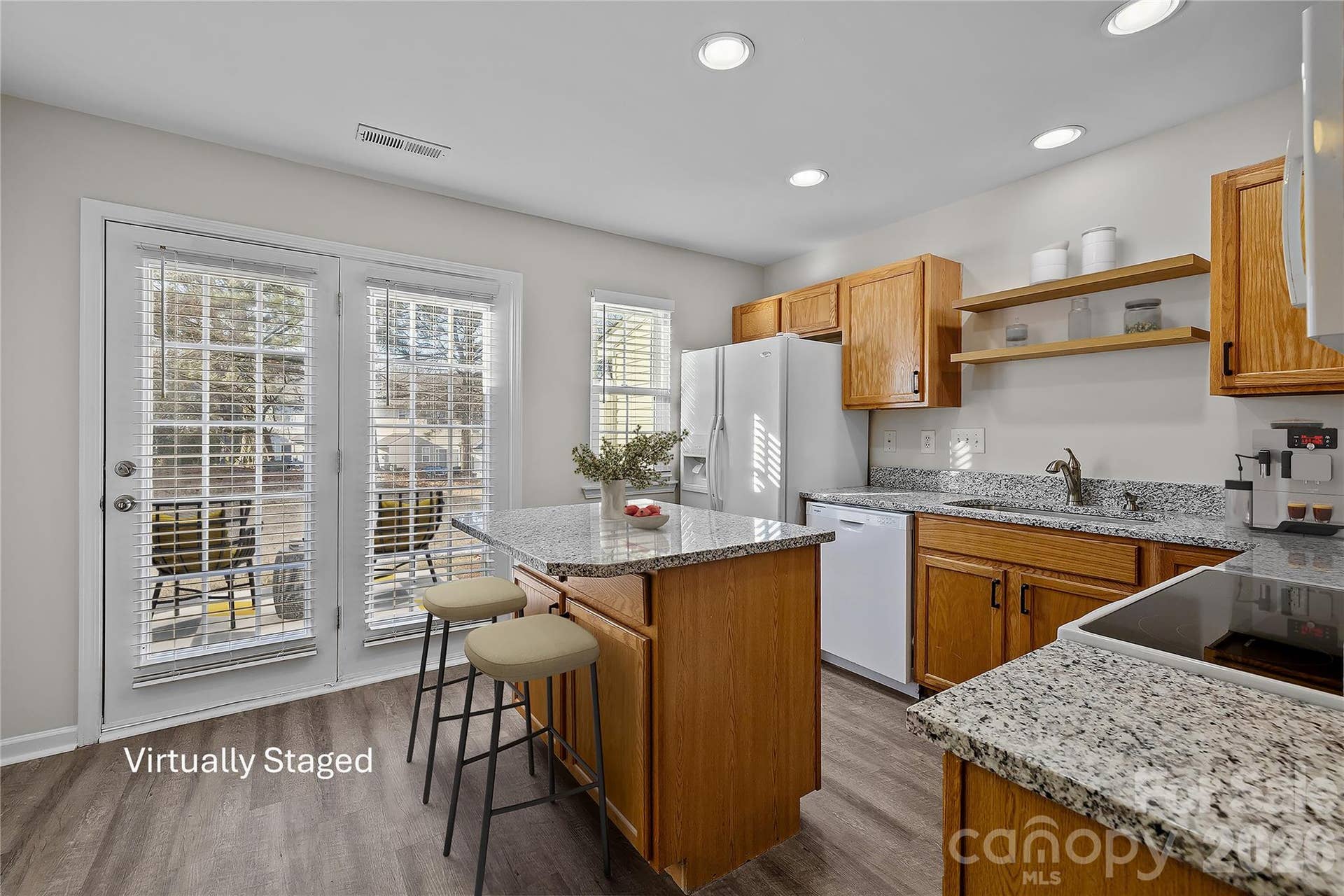 French door leading to patio, plus French window and side window provide fantastic natural light in the kitchen.