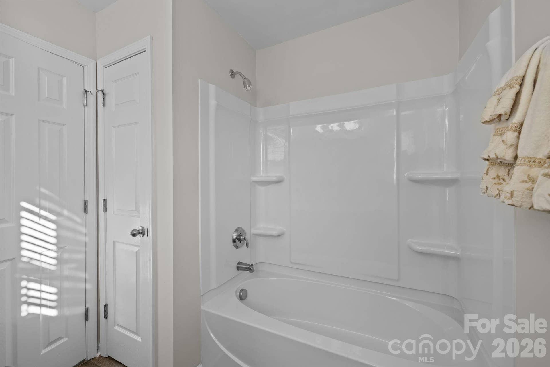 Brand new shower surround in bathroom. Linen closet, fresh paint, easy maintenance flooring.
