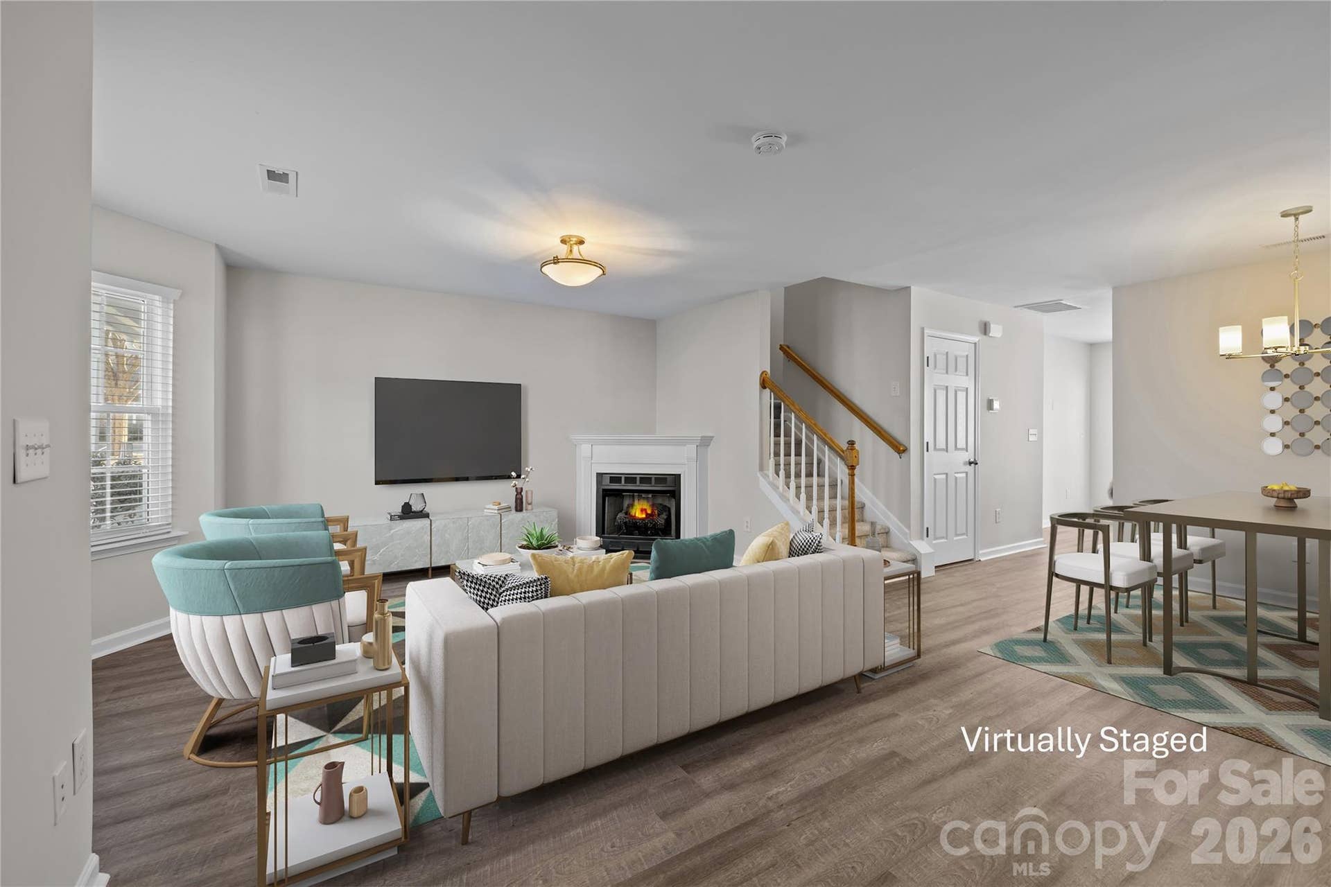 Gas log fireplace with classic mantel anchors the living area, creating a natural gathering spot and a clear focal point for the room. The layout keeps seating comfortably centered around the fireplace while maintaining an easy connection to the dining space.