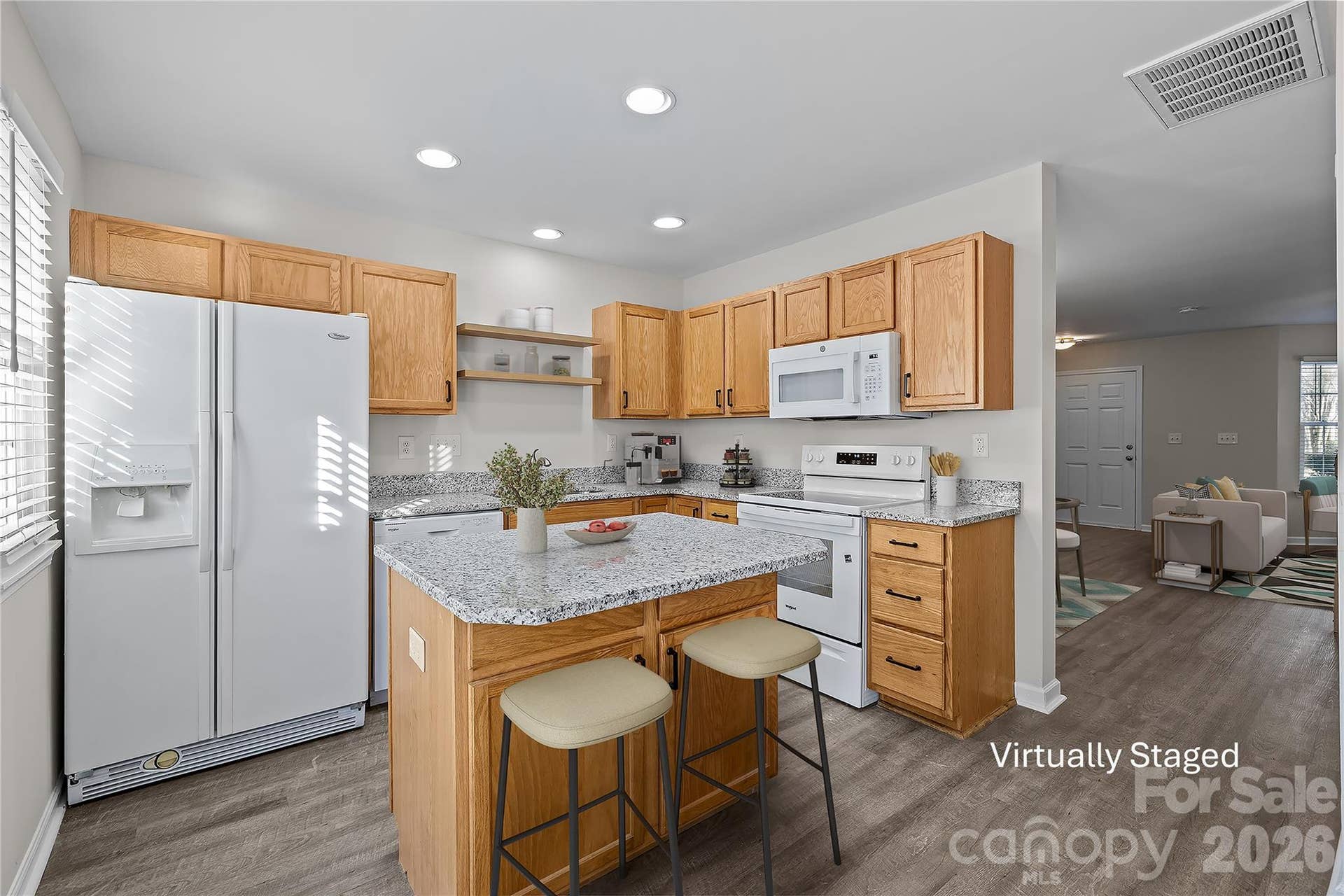Center island with seating provides additional prep space, storage, and casual dining space.