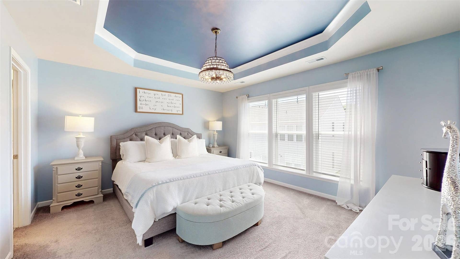 Primary bedroom with stunning tray ceiling.