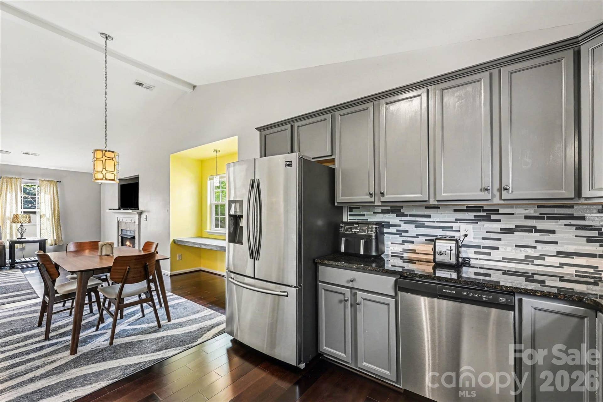 Updated kitchen with backsplash, new dishwasher and refreshed cabinetry