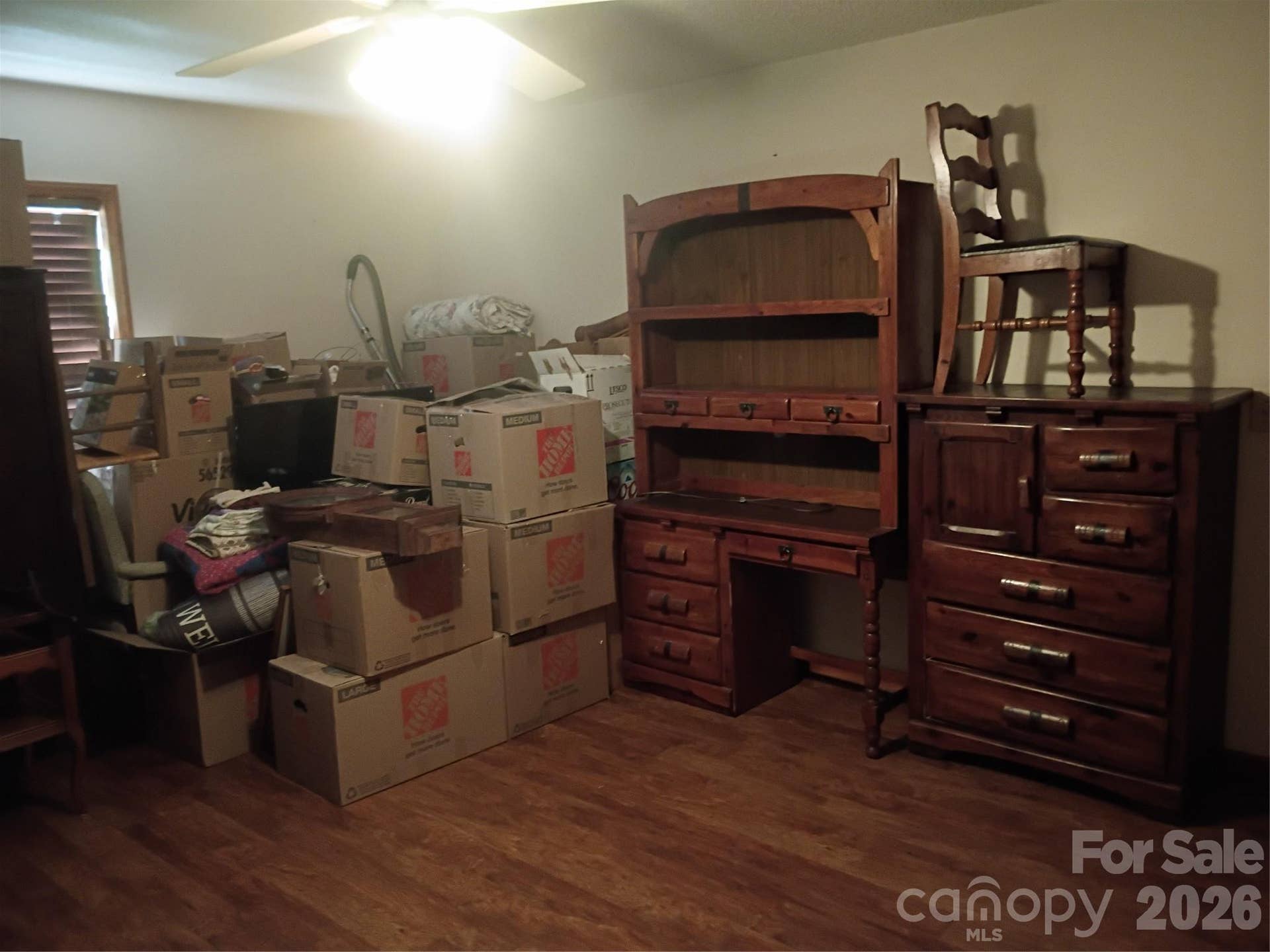 Primary Bedroom please excuse the boxes .
