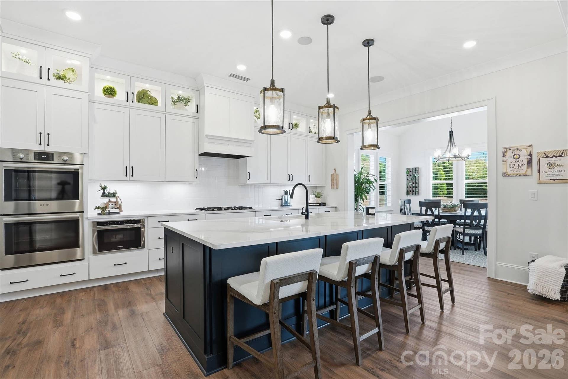 Large kitchen with custom cabinets and island with quartz countertops