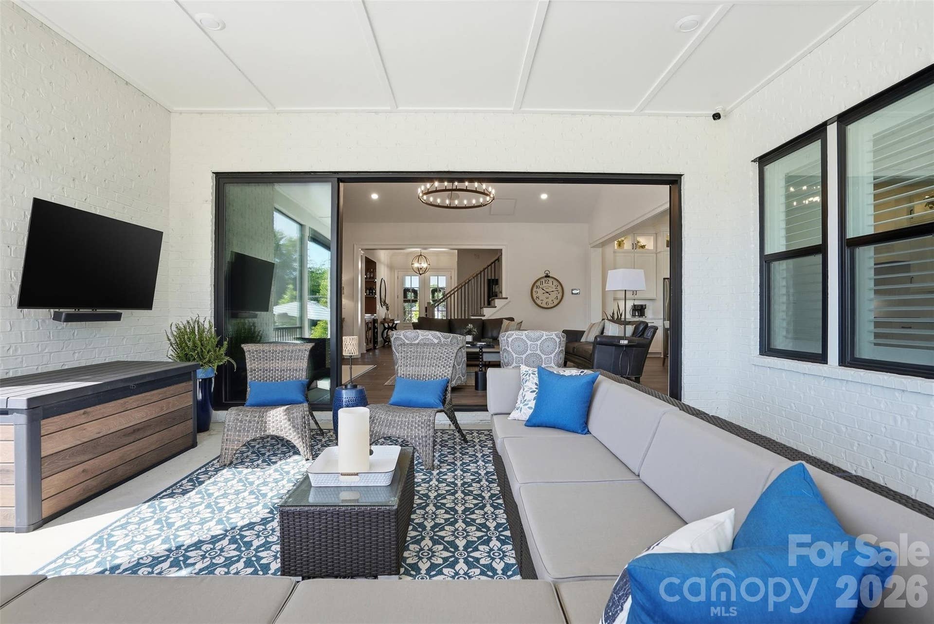 Covered, screened porch that opens into great room