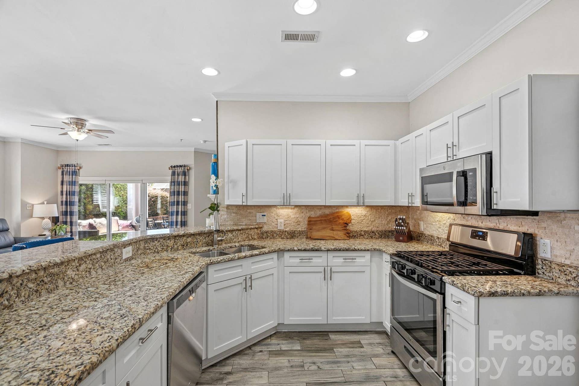 Thoughtfully designed for everyday living and entertaining, the open kitchen features stainless steel appliances, abundant storage, and generous counter space for effortless meal preparation.