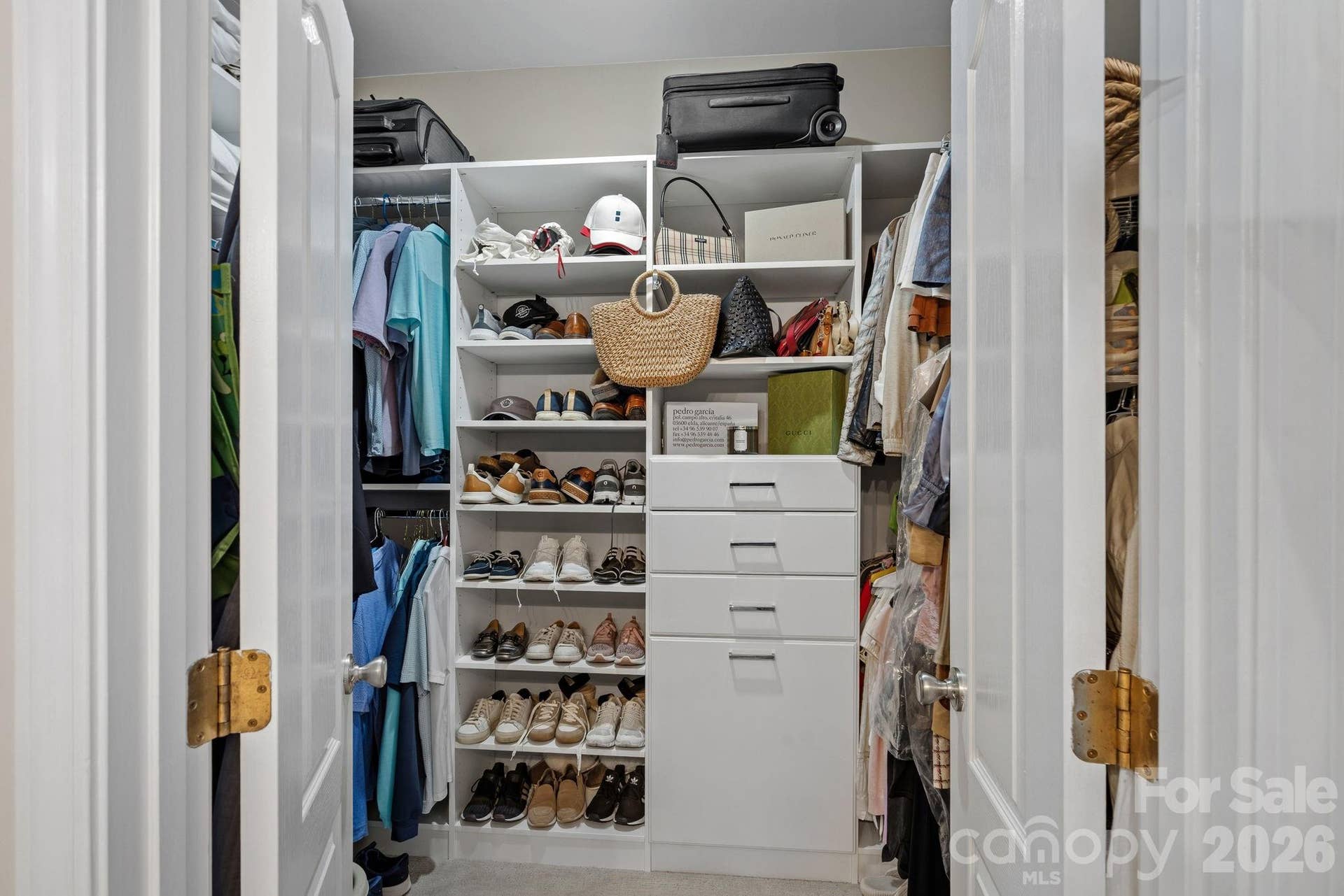 Sparkling primary ensuite with a dual vanity, separate garden tub/shower combo, and spacious walk-in closet.