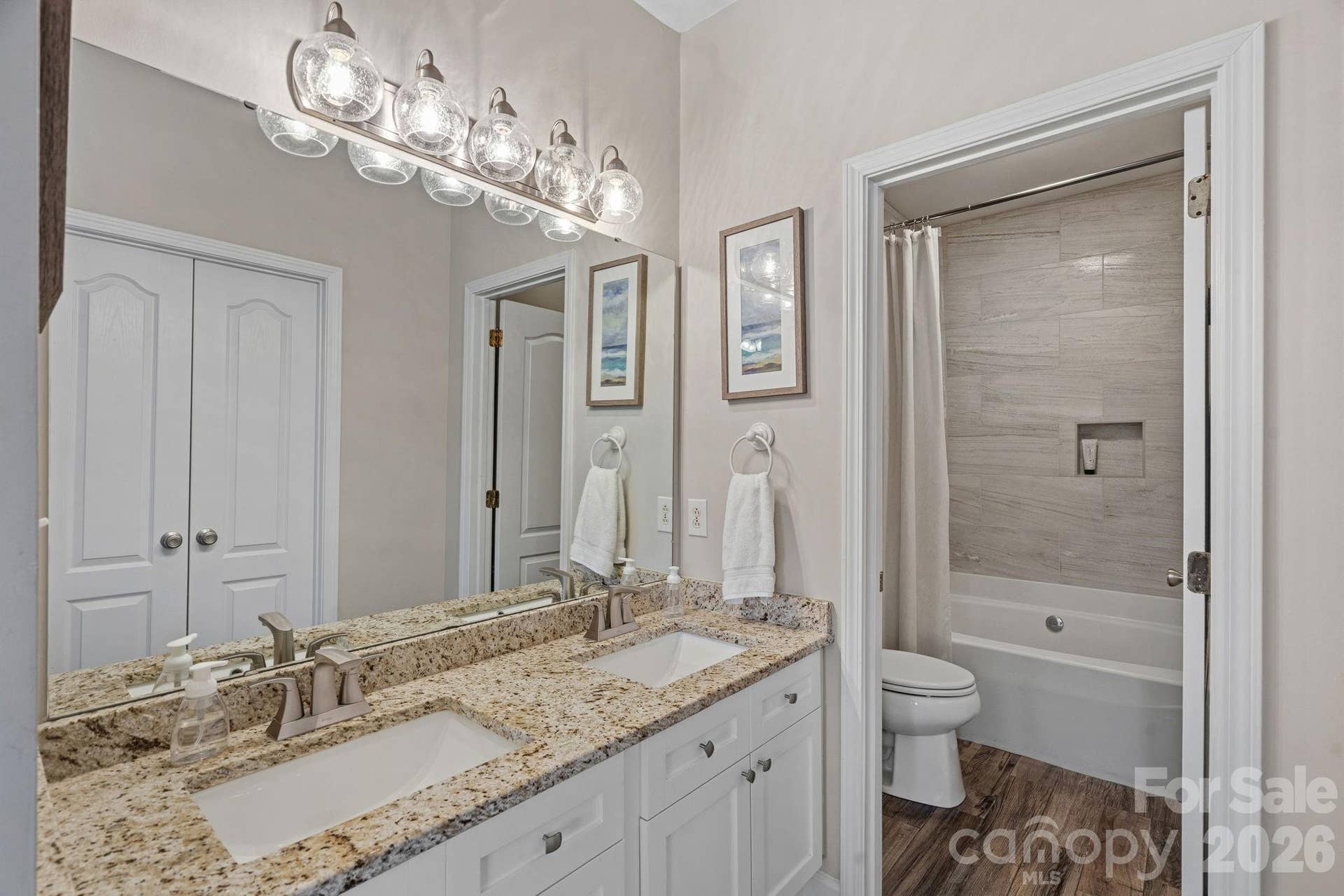Sparkling primary ensuite with a dual vanity, separate garden tub/shower combo, and spacious walk-in closet.