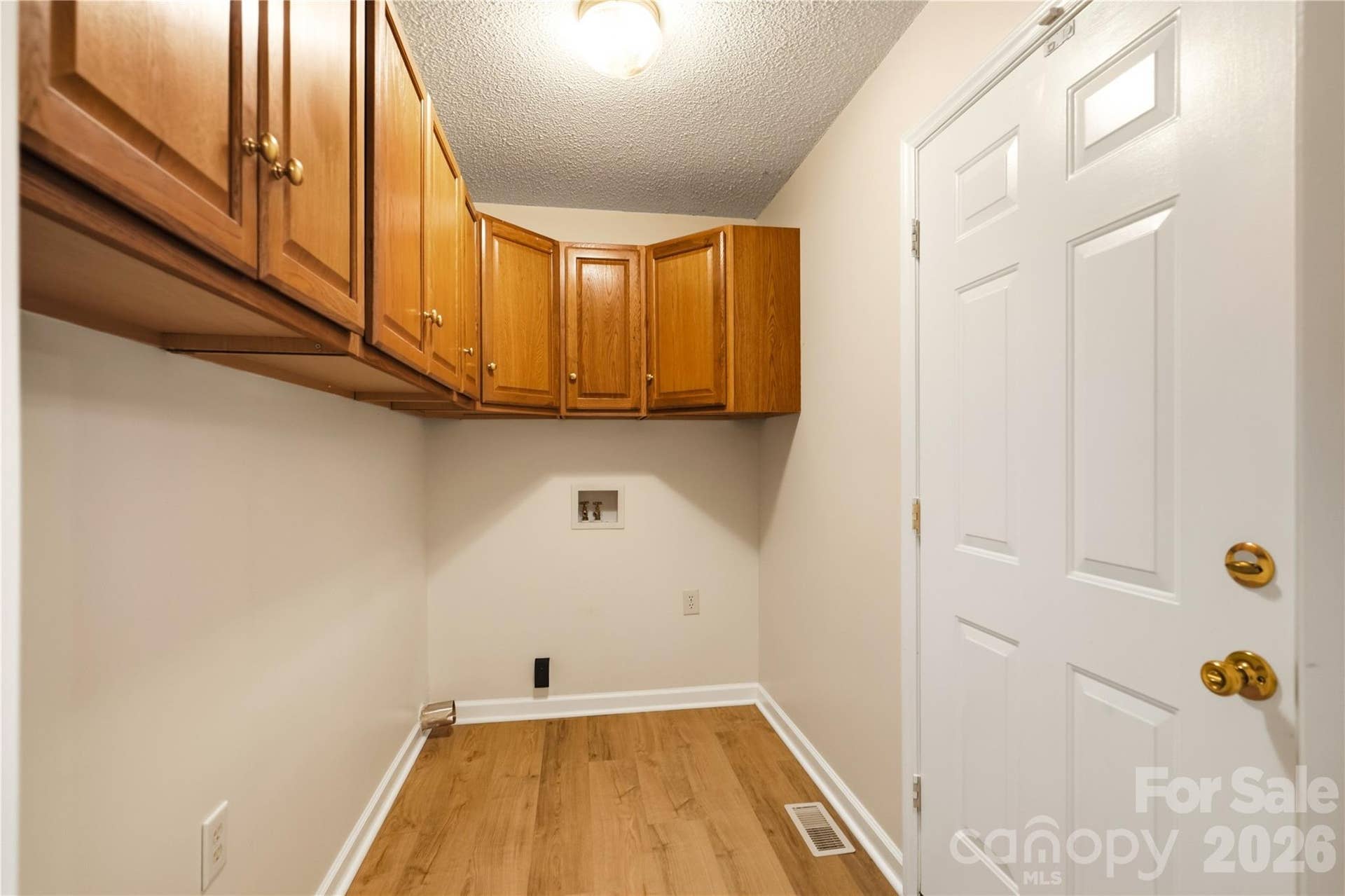 3892 Stoney Creek Drive, Lincolnton, NC 28092 Laundry room with built-in cabinetry offering additional storage and workspace.