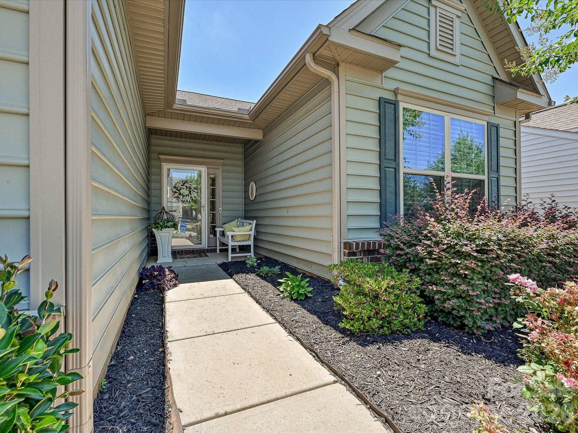 Recessed entry has room for garden bench
