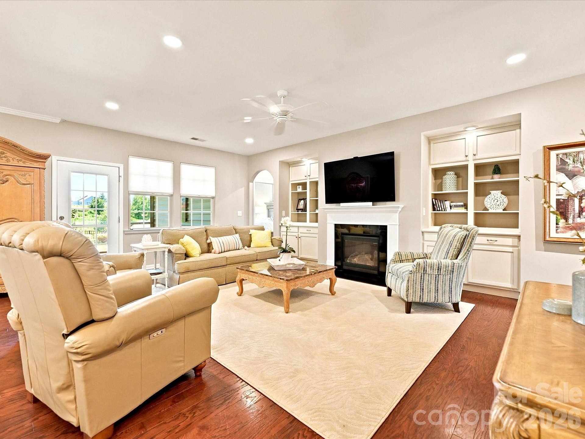 Great room with hardwood floors, gas fireplace and custom built ins