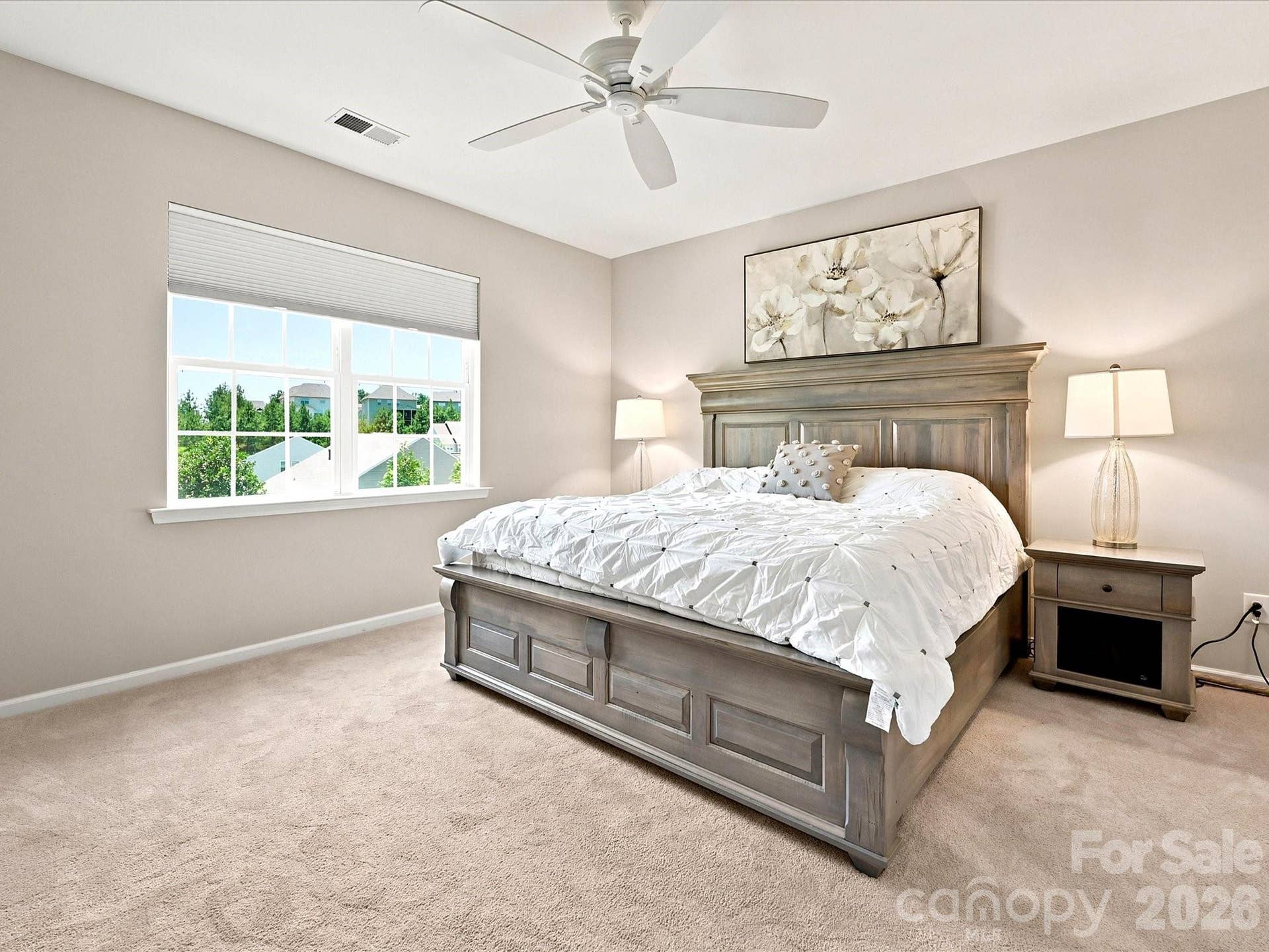 Primary bedroom with views of rear yard