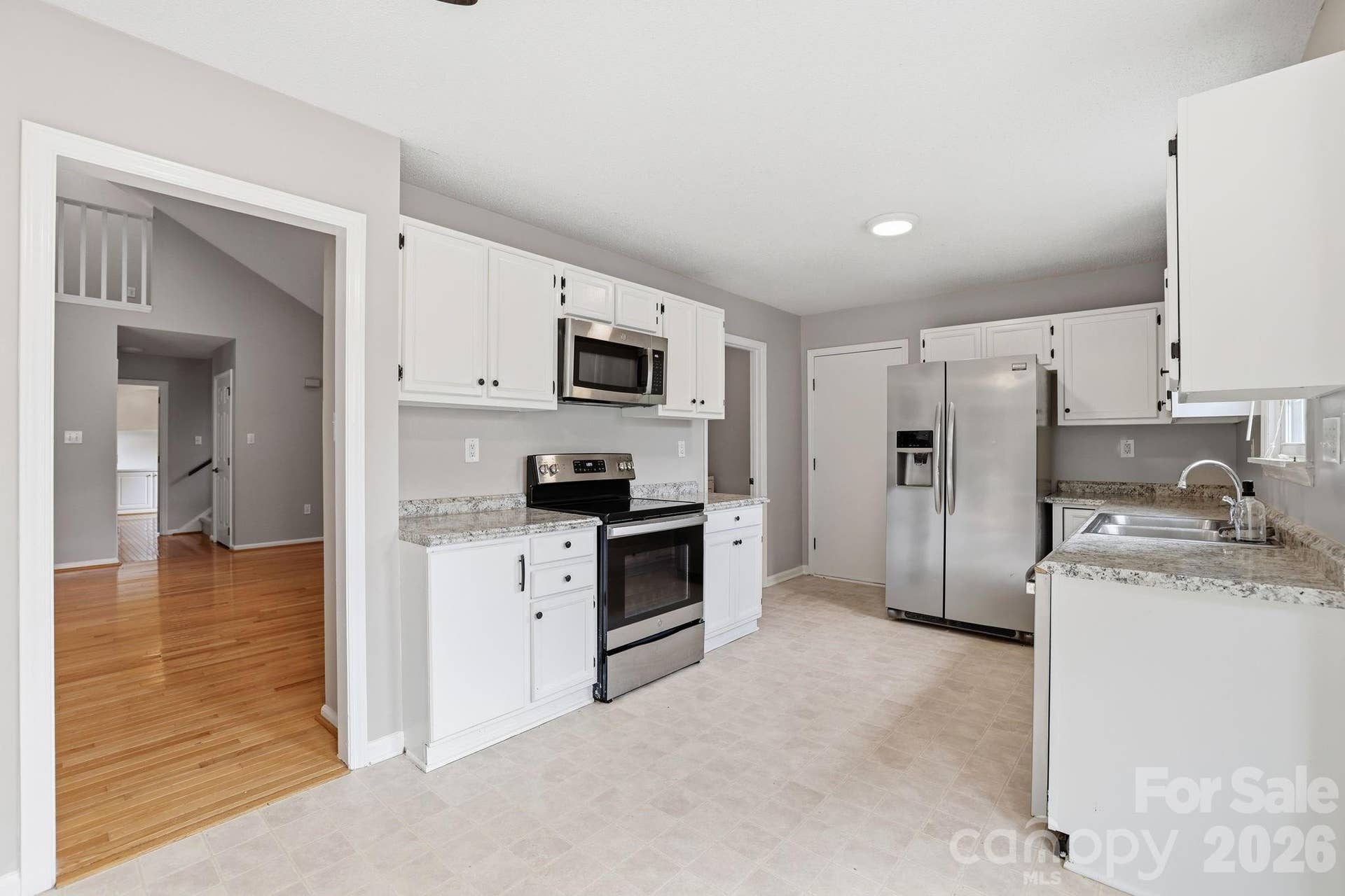 7038 Chelsea Day Lane, Tega Cay, SC 29708 Kitchen White Cabinets with Stainless Steel Appliances