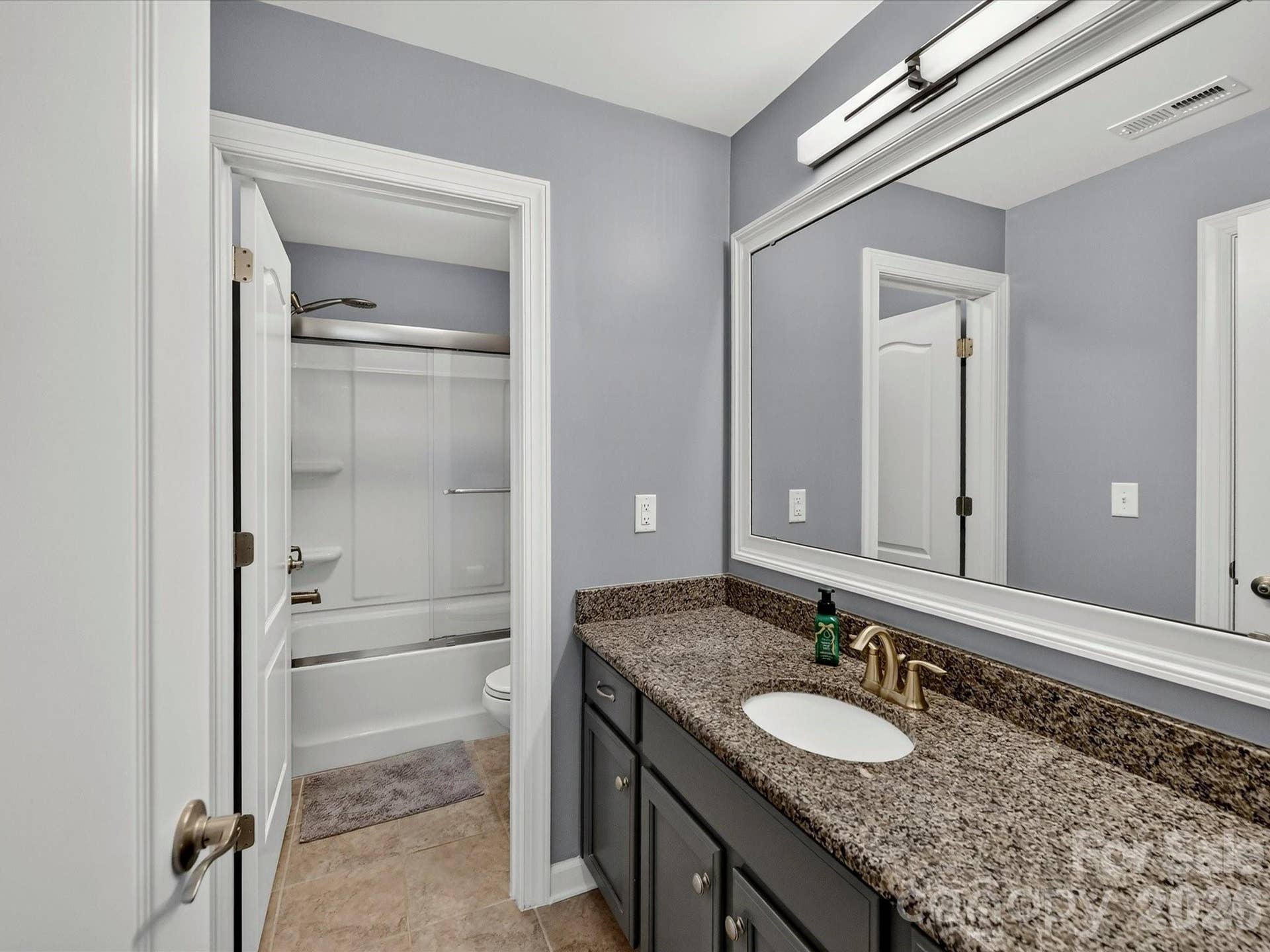 Full Bath 3 Upper Level with Tiled Flooring, Granite Counters and Framed Mirrors. Upgraded Light Fixture