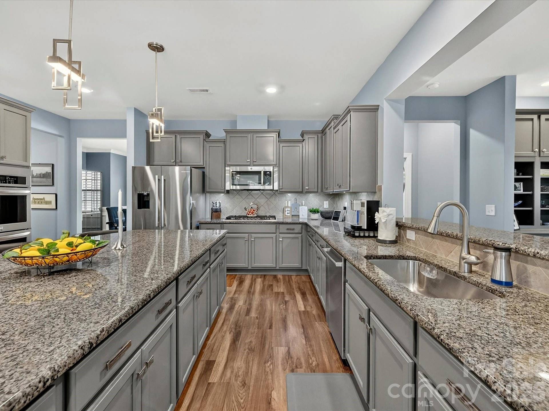 "Gourmet Kitchen Includes 5 Burner Gas Range, Two Built-in Wall Convection Ovens, Upgraded Cabinetry & Backsplash. Single Bowl Sink and Custom Drawer PUlls and Knobs