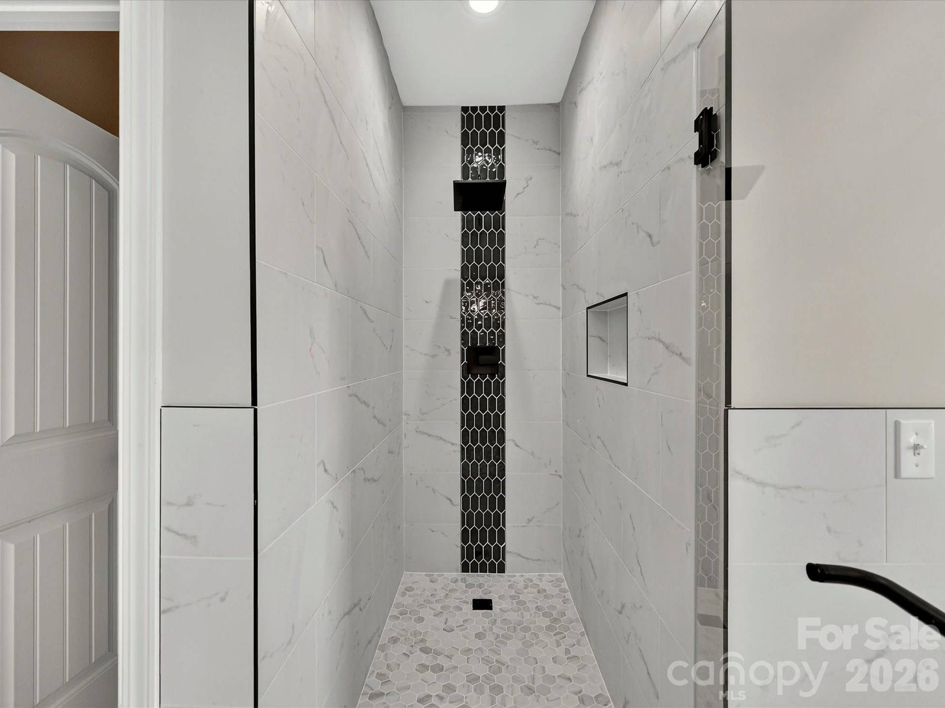 The luxurious primary bath offers a spa inspired retreat with dual vanities, a freestanding soaking tub, an oversized tiled walk in shower, and elegant designer finishes throughout.