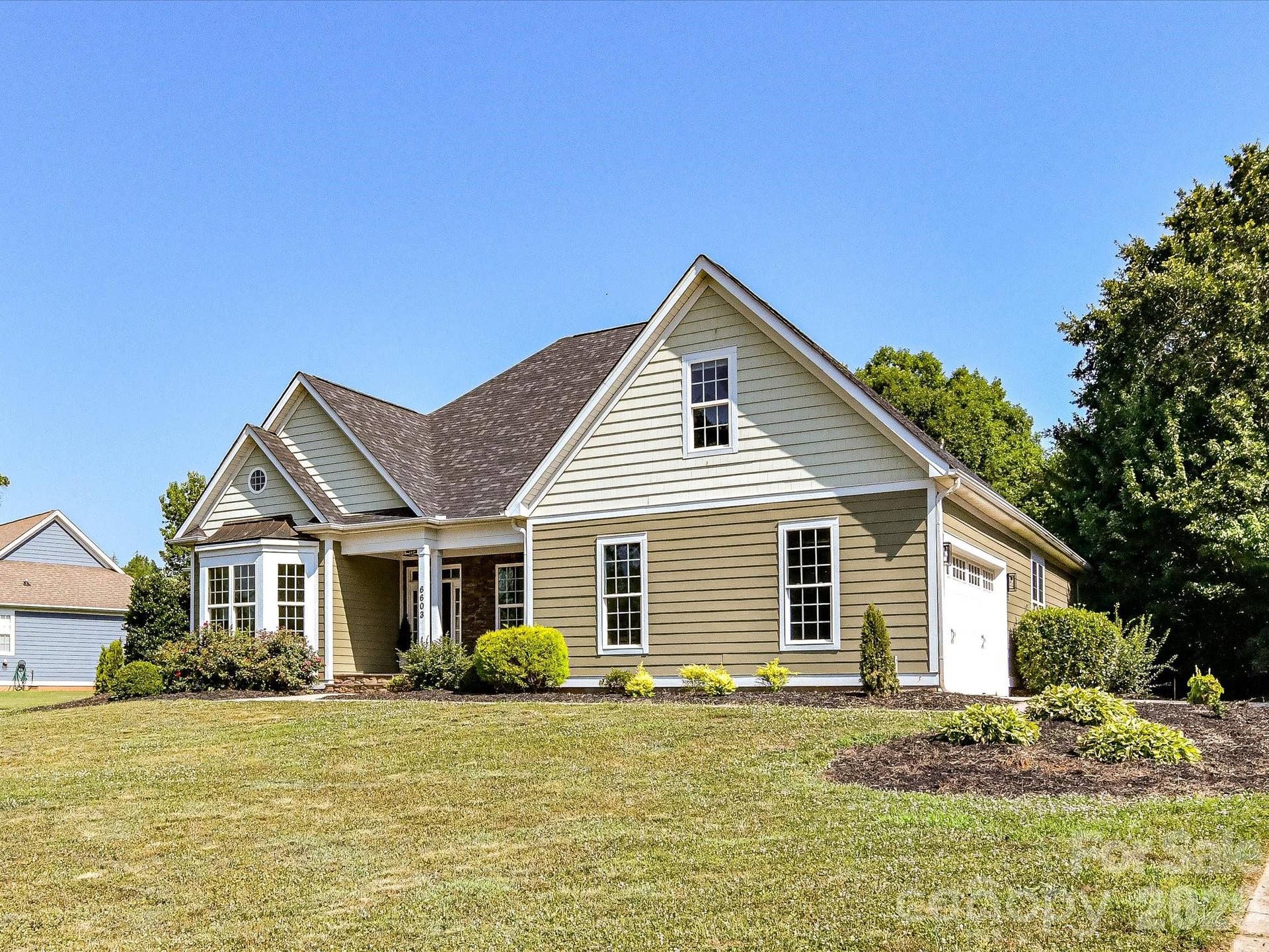 Beautifully maintained with timeless architectural design, this home showcases attractive landscaping, a welcoming covered entry, and an oversized side-entry garage on a spacious homesite.