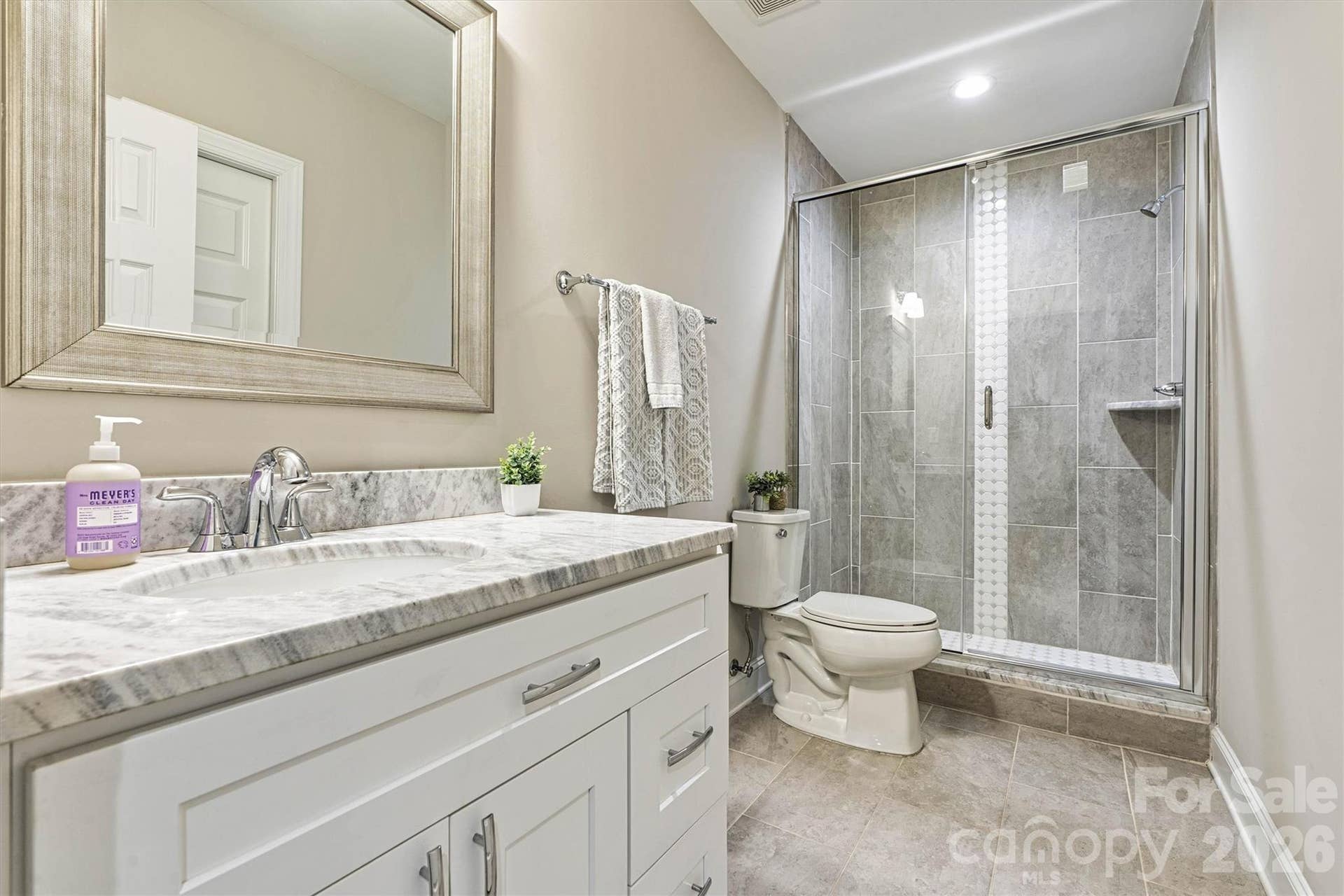 Full tiled bathroom with tiled shower for guests/family in the lower level