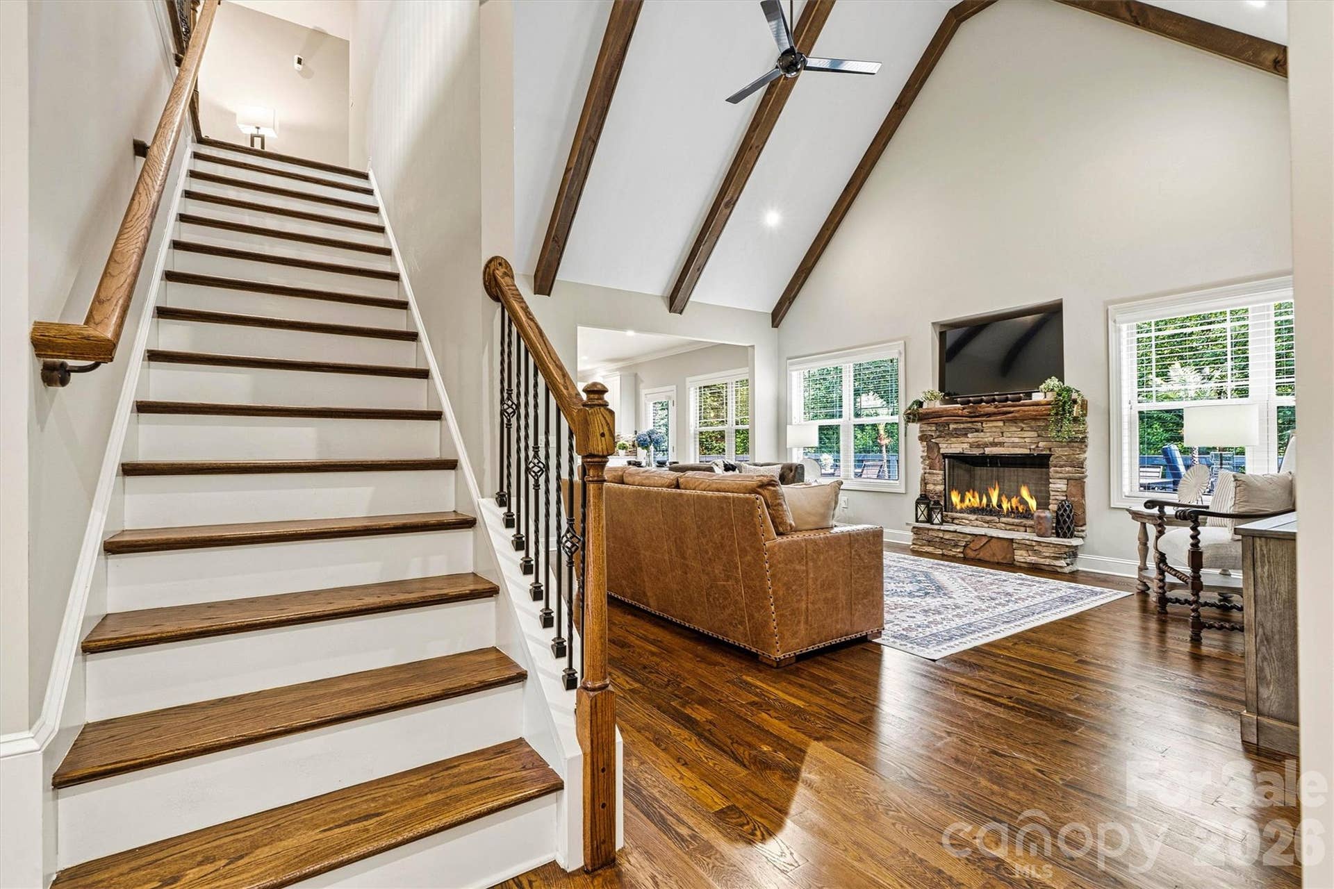 Hard wood floors throughout the home and exposed beams create an inviting space