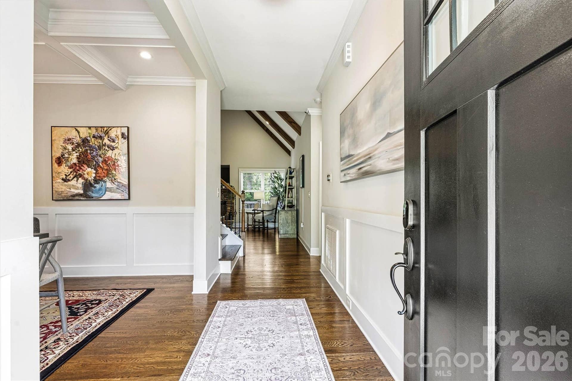Beautiful entrance opening to the dining room with cofferred ceilings