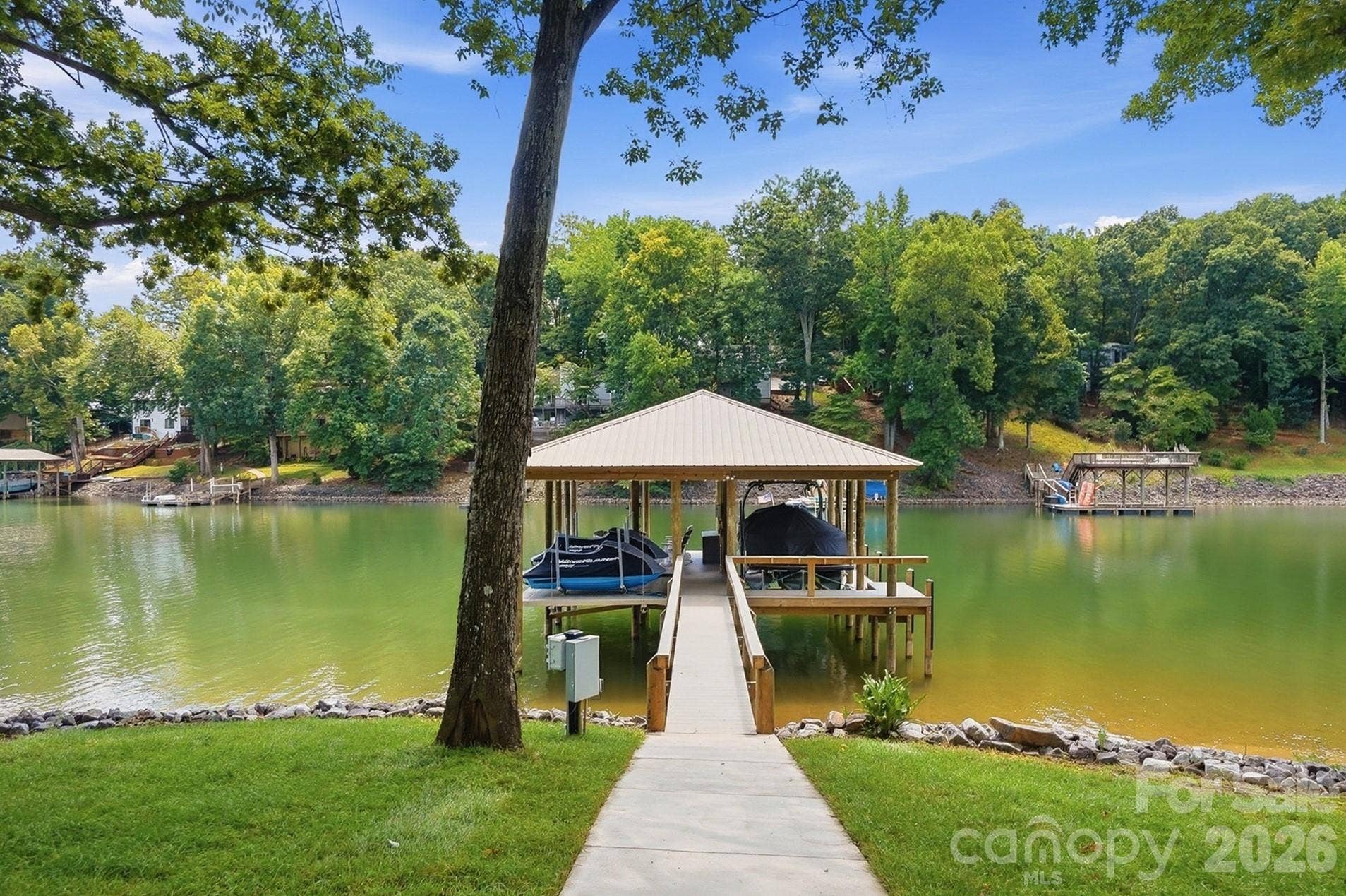 Boating enthusiasts will appreciate the covered dock with boat lift and jet ski lifts, offering easy access to endless days on the water