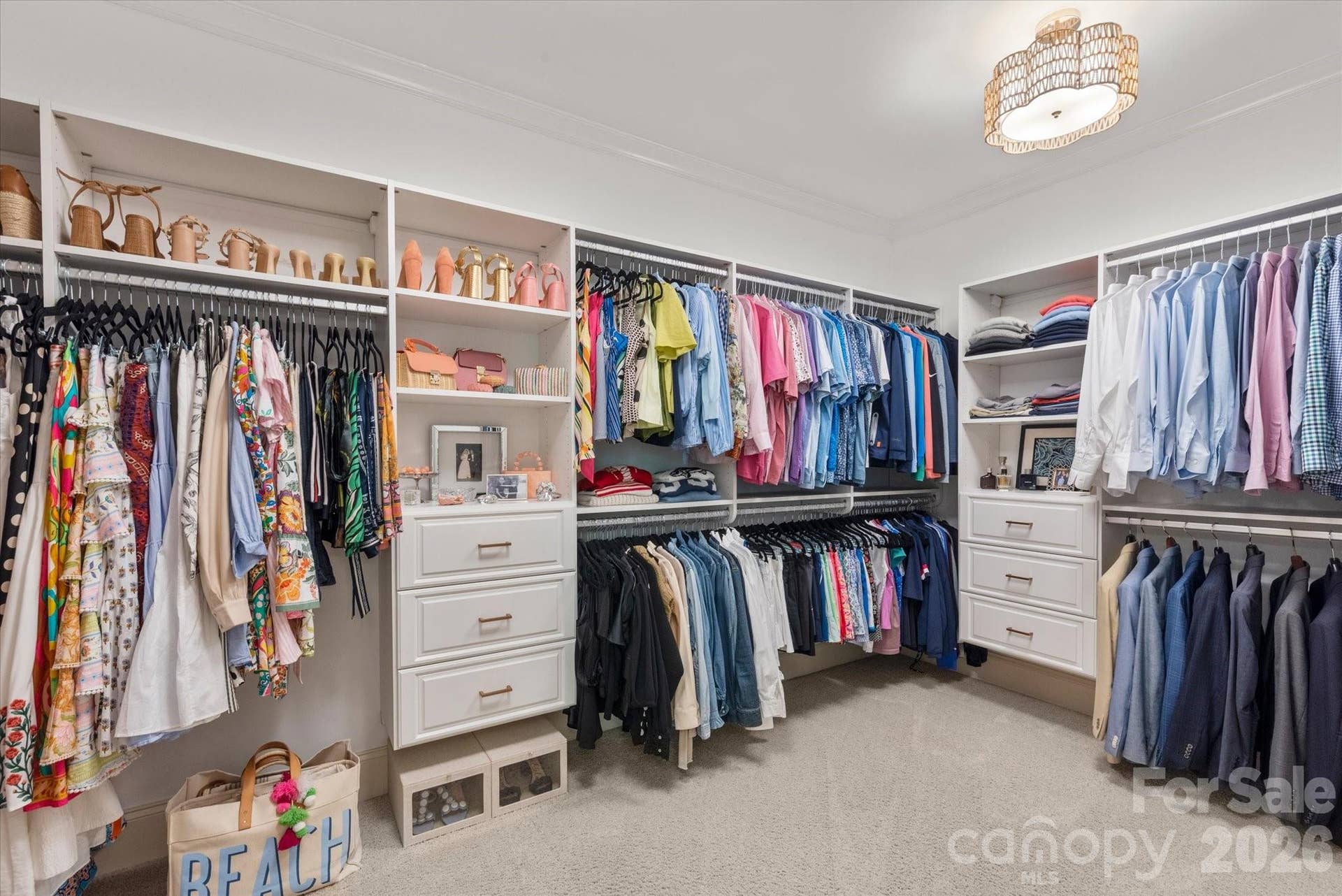 A boutique-inspired walk-in closet outfitted with custom storage systems to maximize organization.