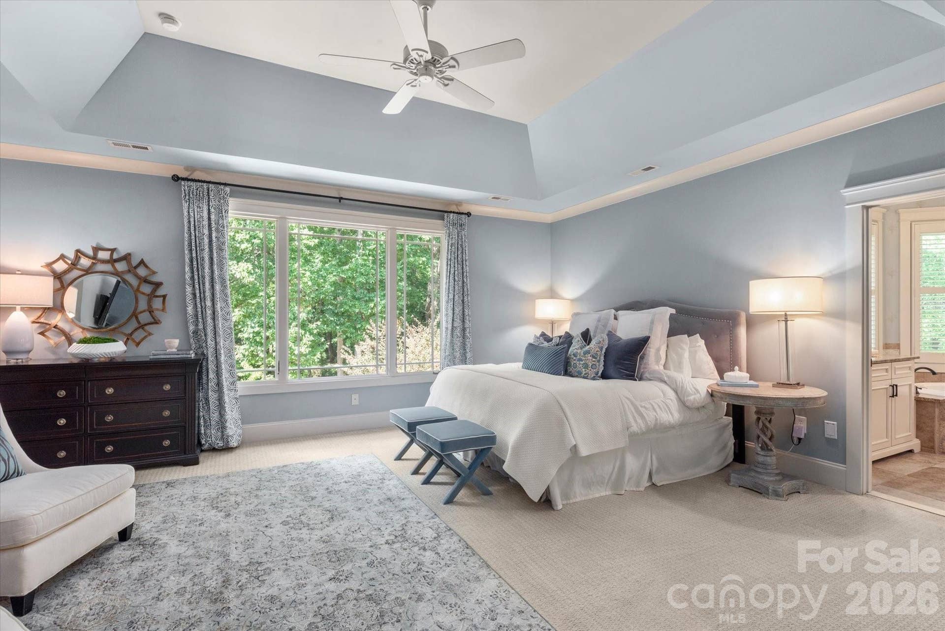 The ultimate owner's retreat, featuring a deep tray ceiling, expansive backyard views, a private sitting area....