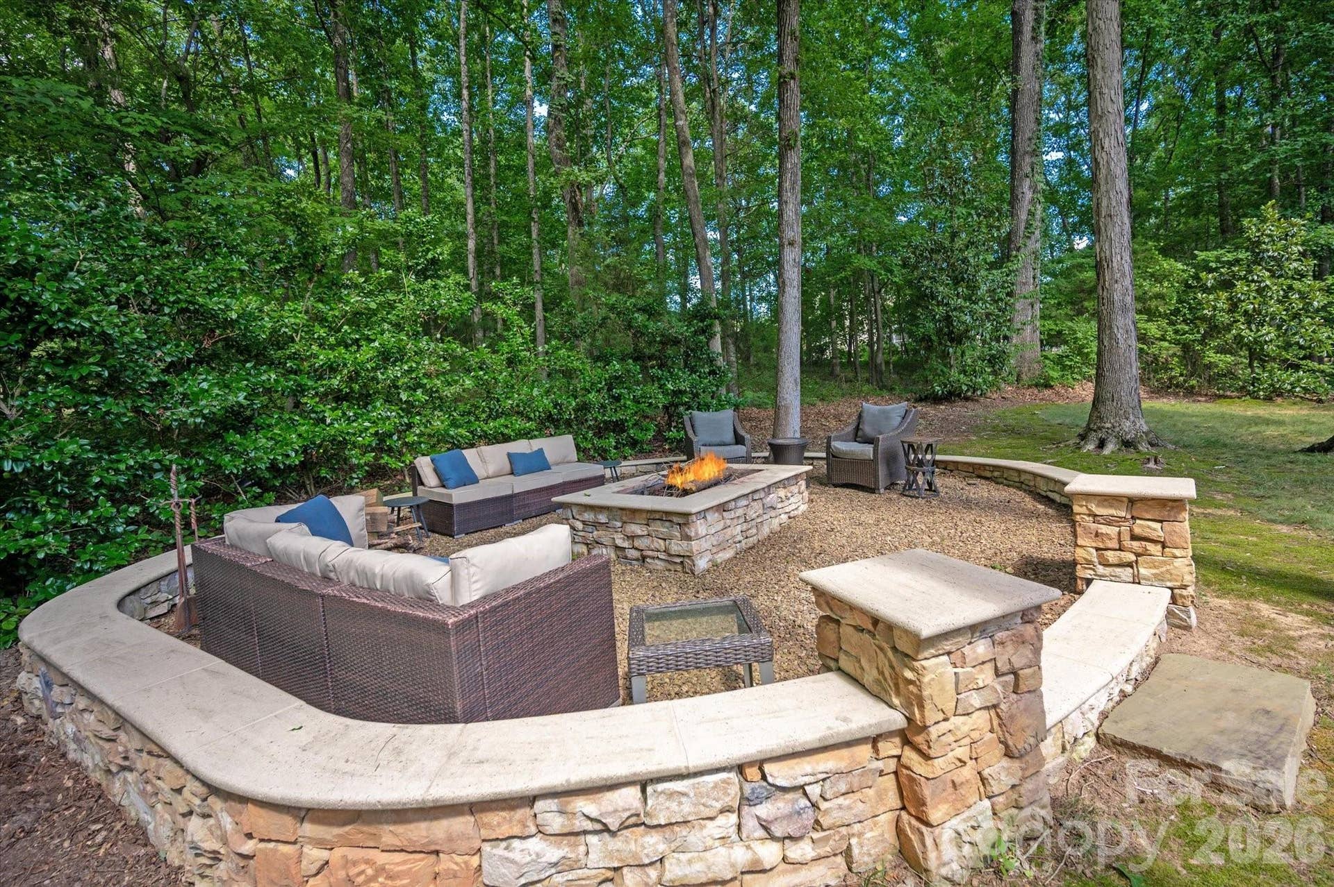 Cozy up under the stars around the custom fire pit, completing your backyard resort experience.