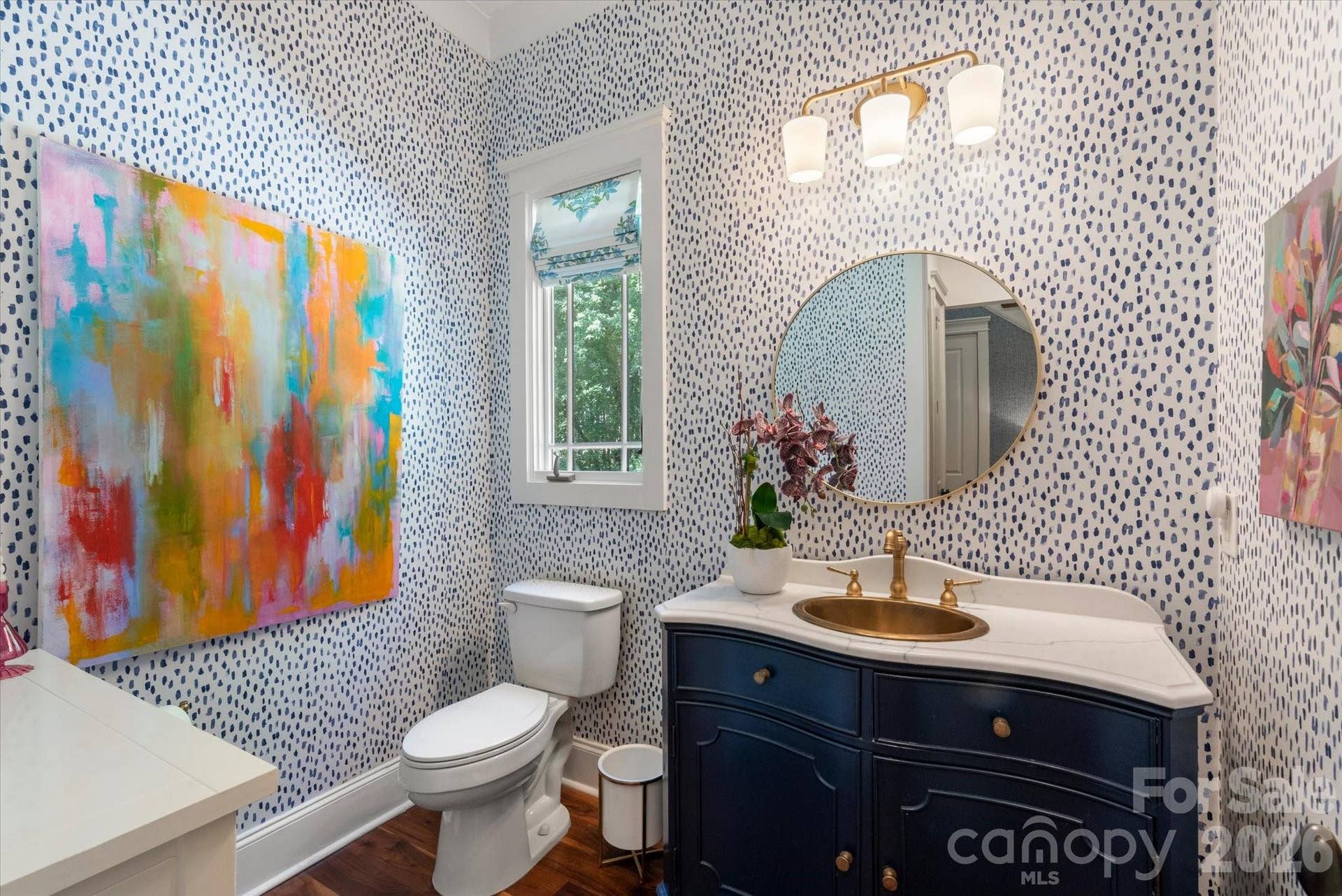 An elegantly appointed main-level half bath showcasing premium designer finishes.