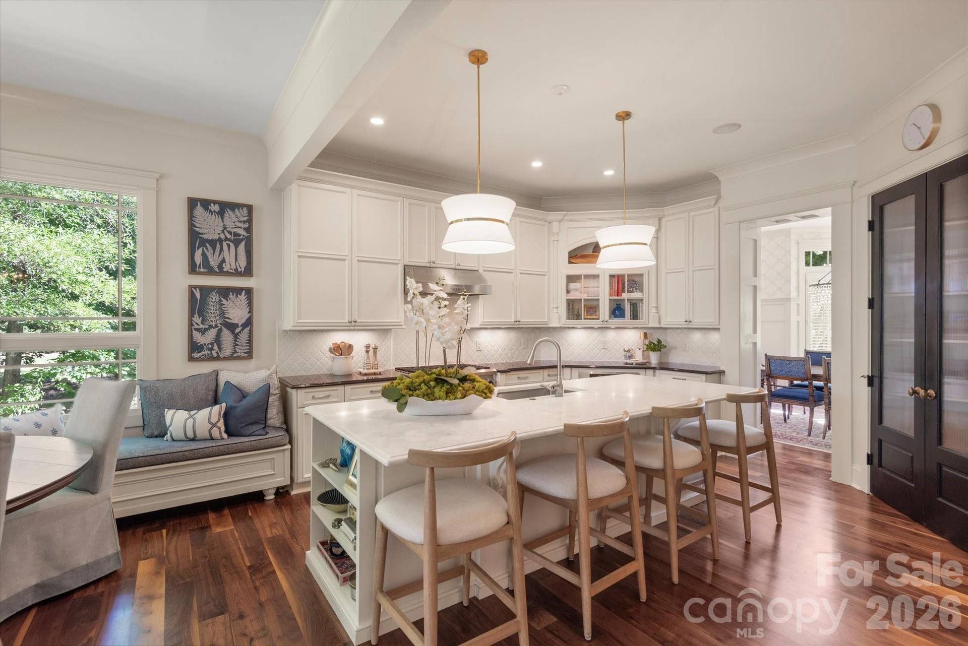 The generous central island serves as a natural anchor for casual entertaining and culinary prep.