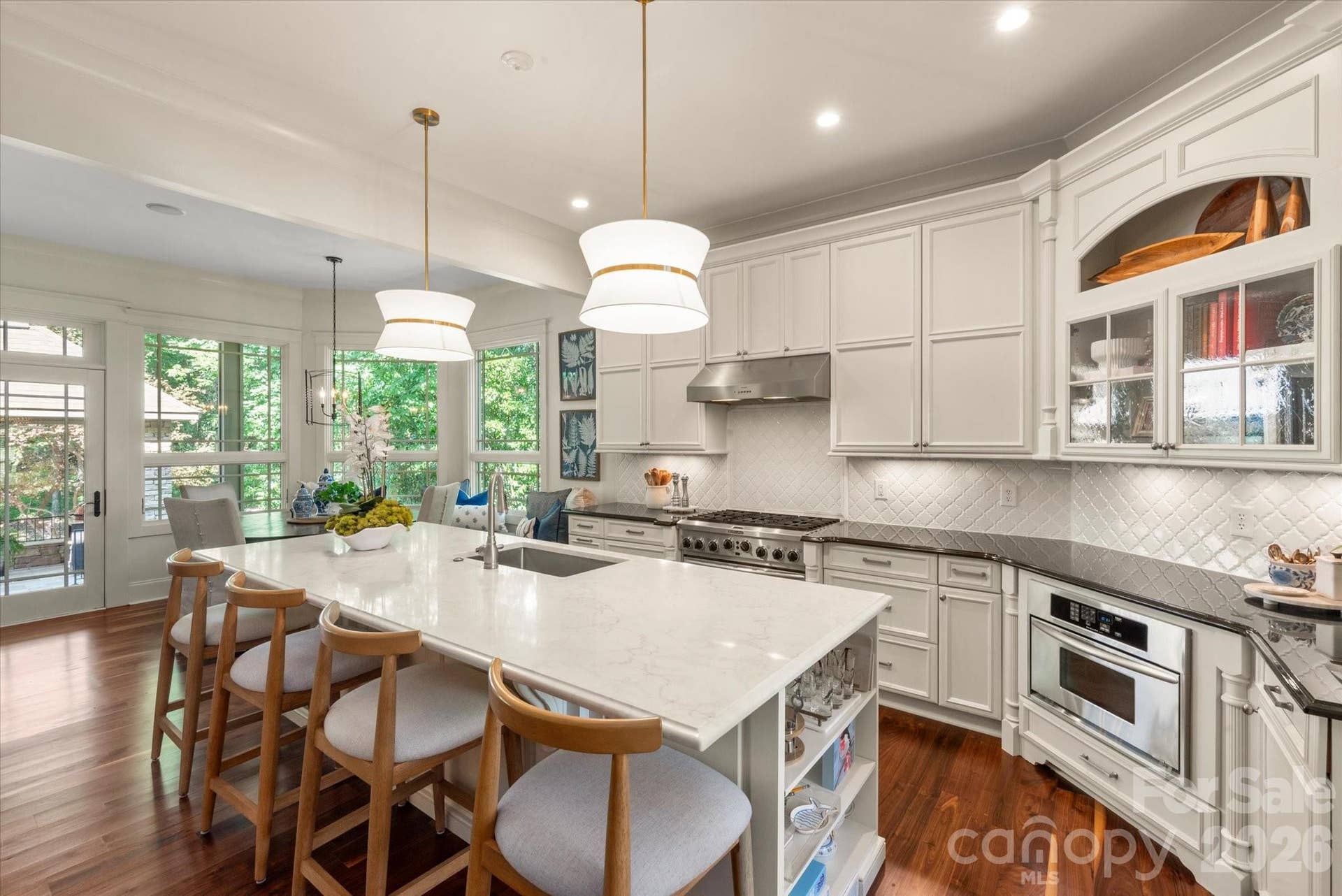 A chefs sanctuary boasting expansive granite countertops, antique white cabinetry, and premium stainless steel appliances.