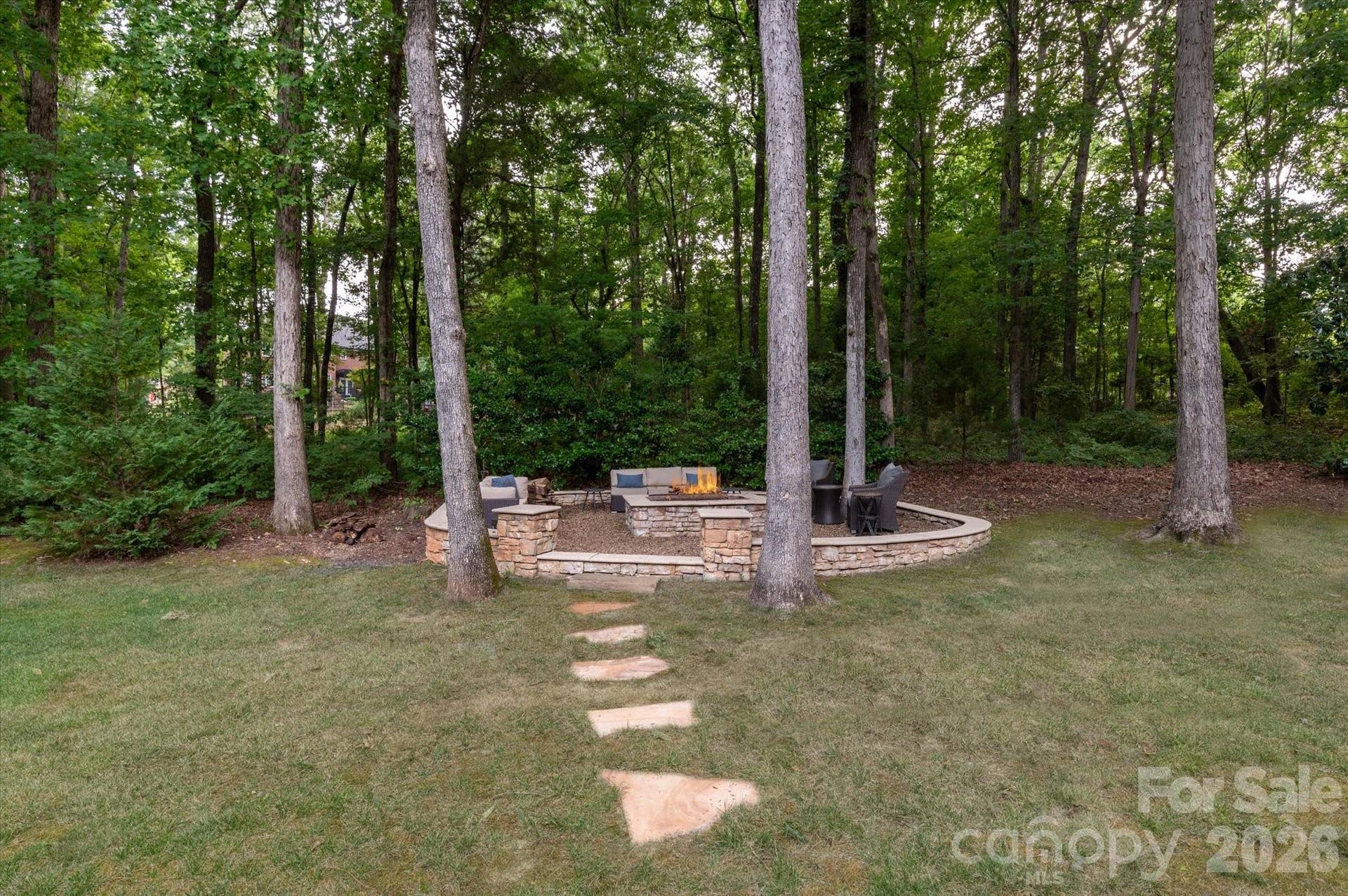 Wooded backyard area offers privacy for intimate gatherings.