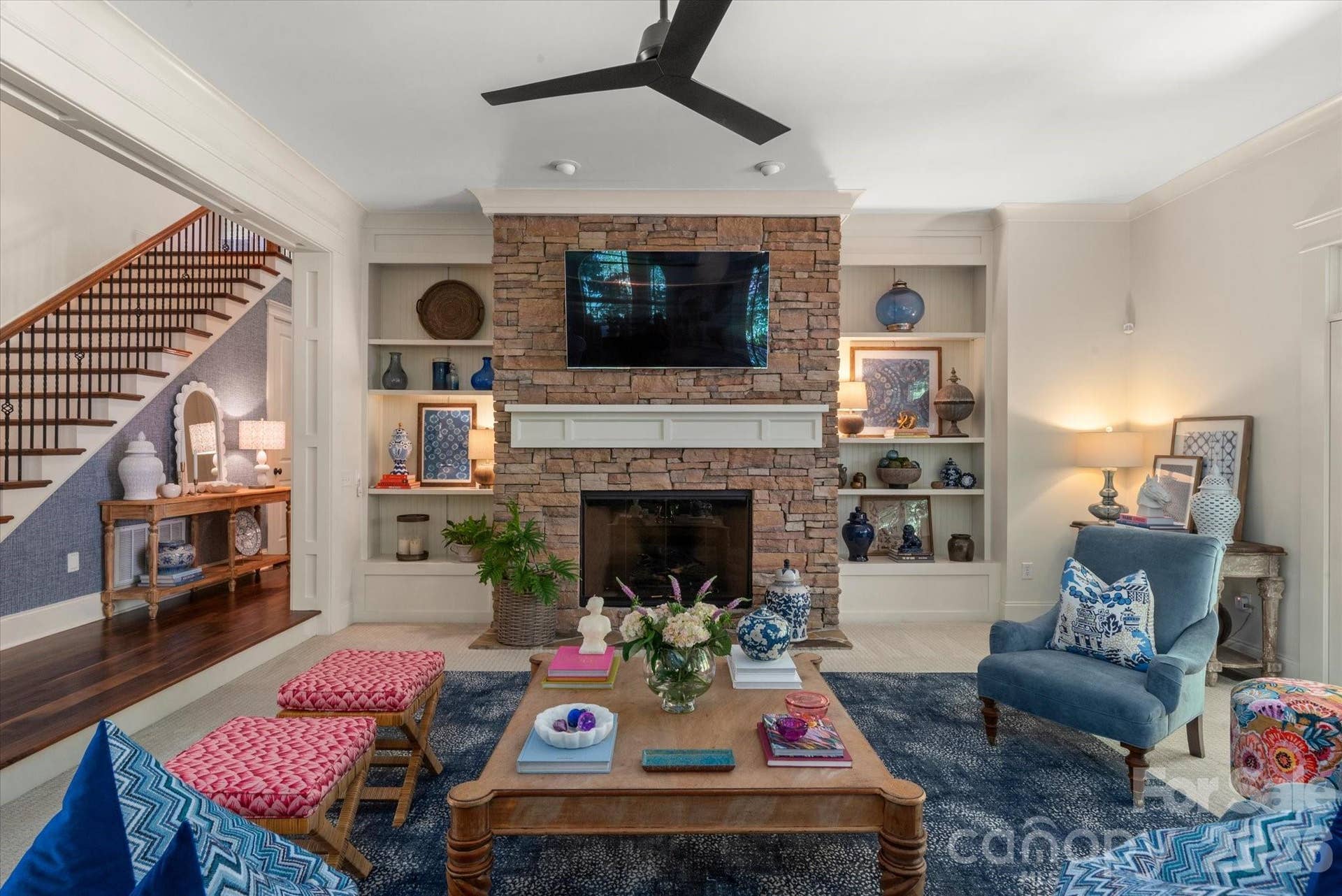 Towering ceilings, commanding stacked-stone fireplace and custom built-ins makes this an inviting place for everyone to gather.
