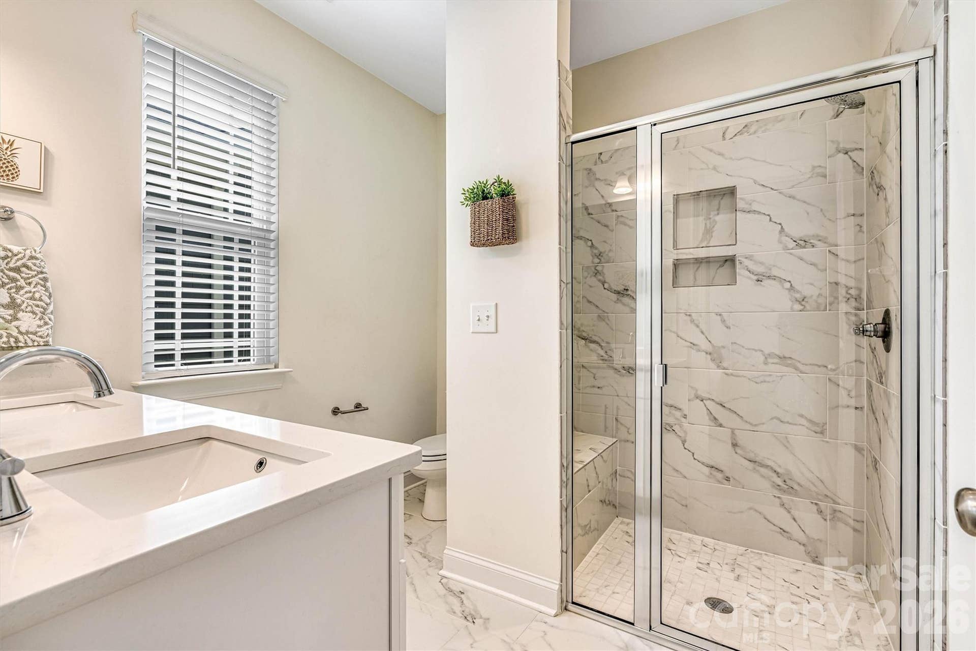 Primary ensuite tiled shower with bench seating