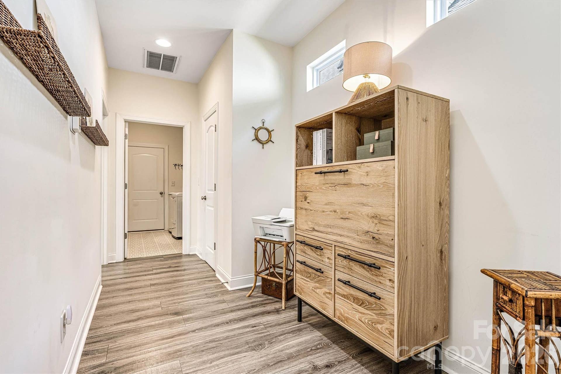 Hall that leads to the primary bedroom from the kitchen