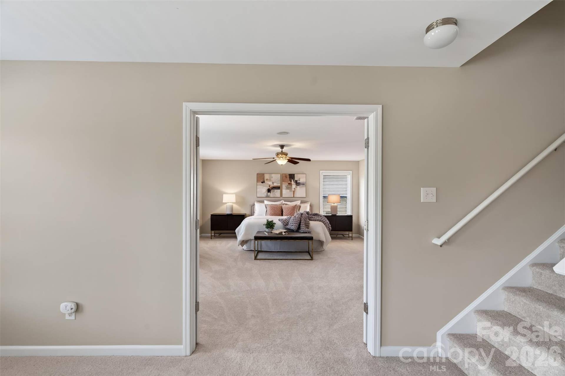 The primary bedroom is just off the loft and accessed by a double door entry