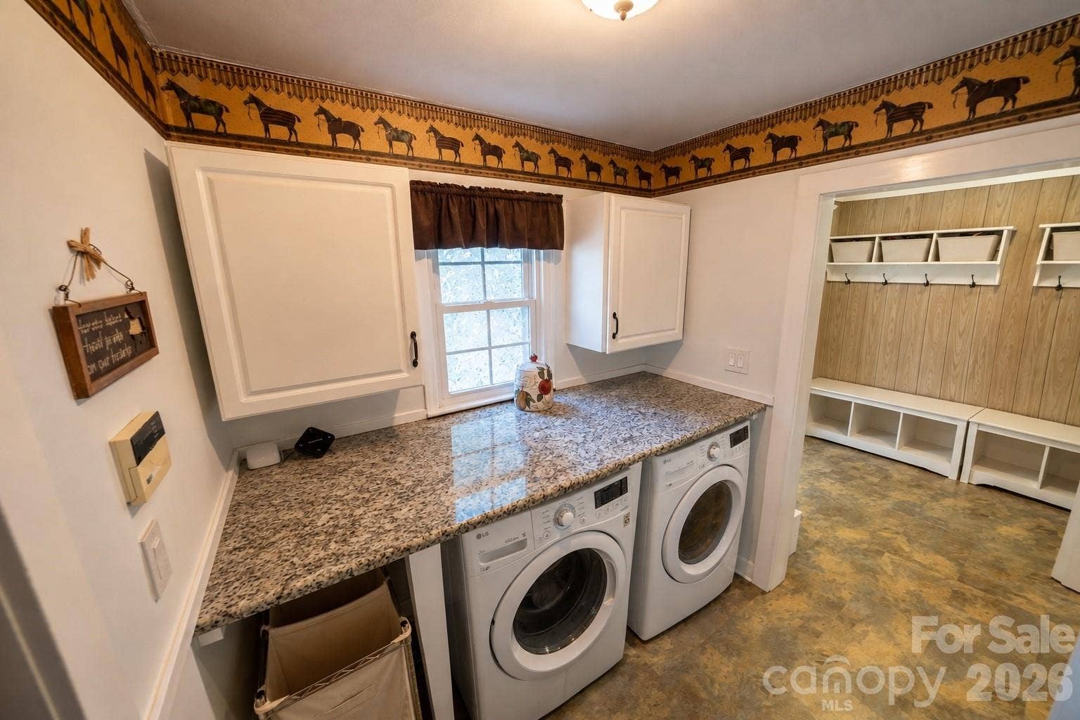Laundry room w/ granite countertops and cabinet storage