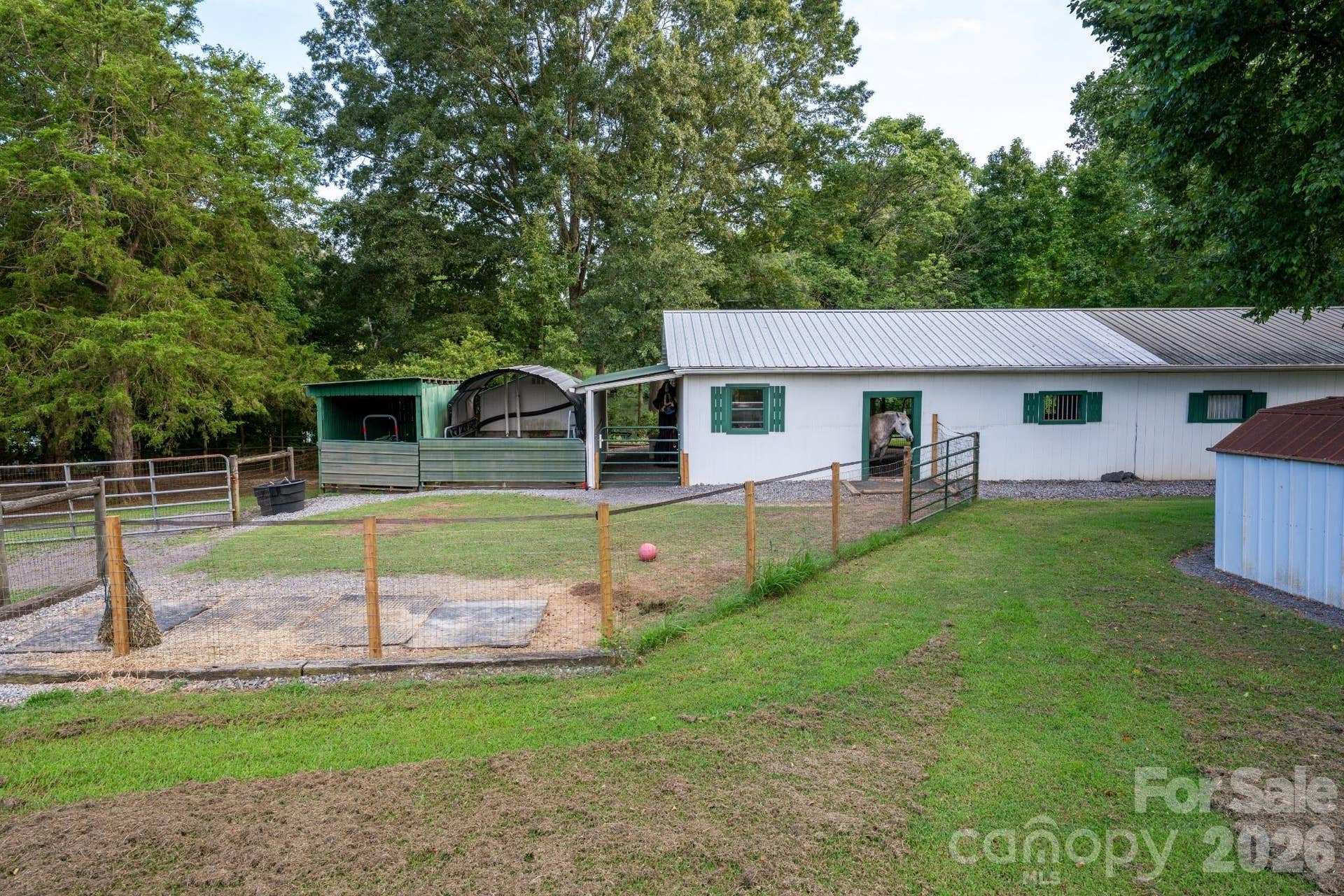 Covered manure and tractor storage connects to the barn