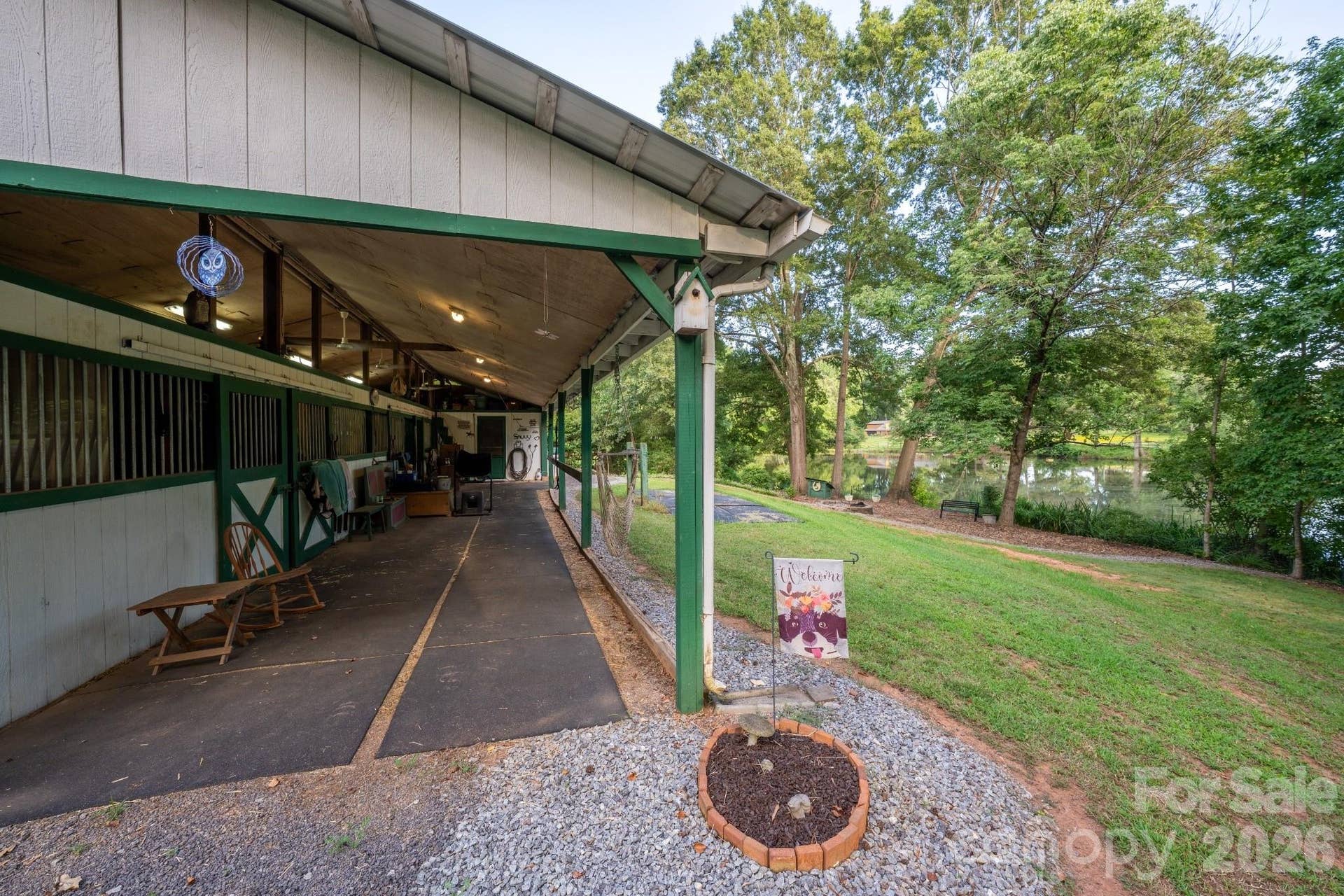 4 stall barn w hay/storage loft with stair access. Barn overlooks scenic and quiet pond