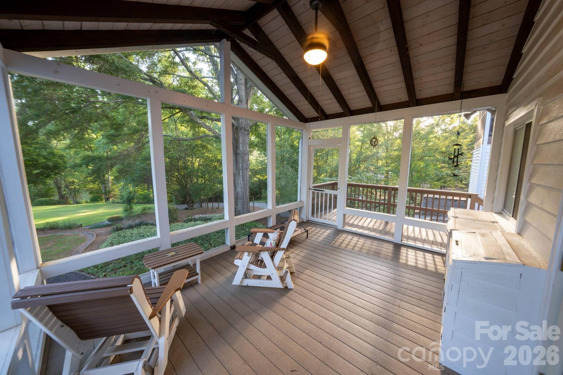 Back screened porch overlooking back yard and pond