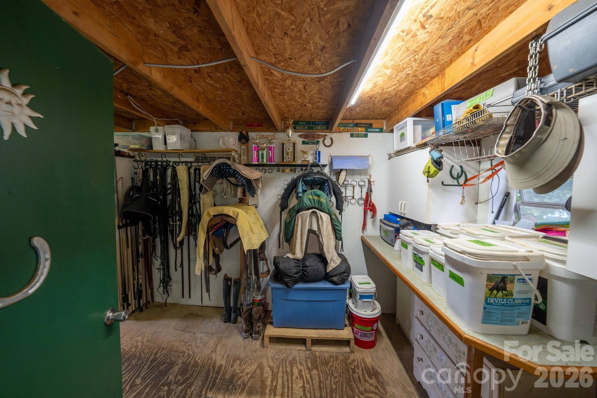 Tack room with countertops and cabinet storage