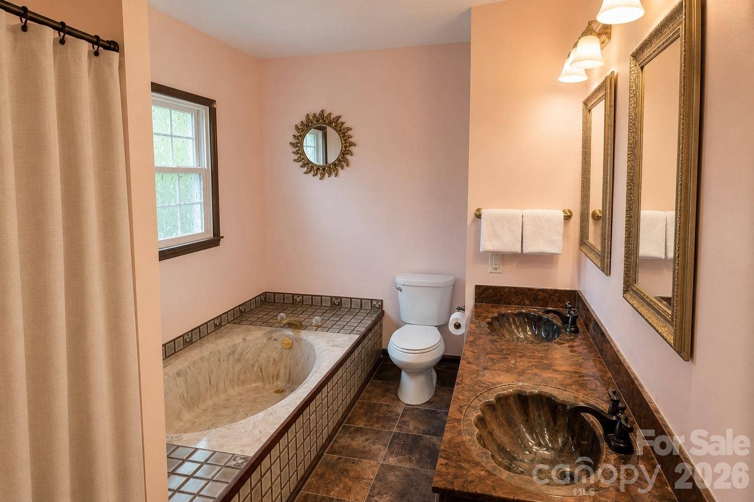 En-suite full bath with dual vanities, shower, and tub