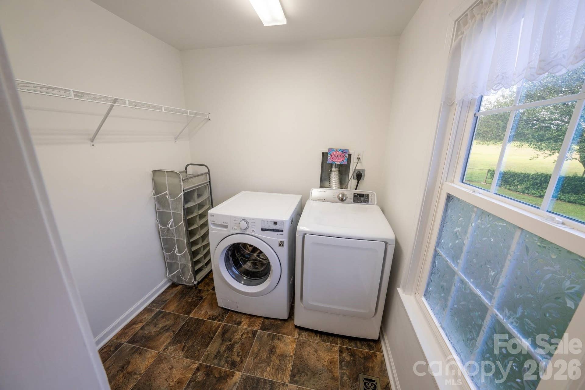 Garage apartment laundry space w/ wire shelving