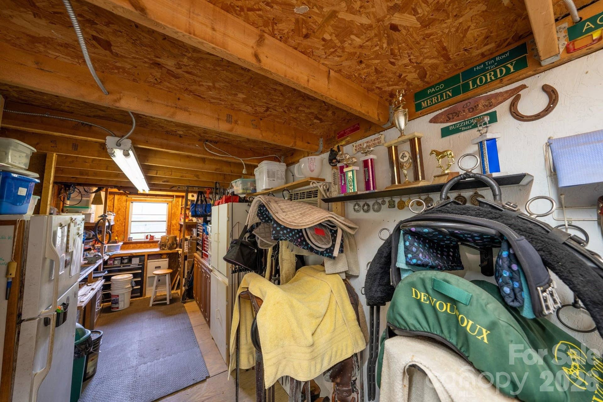 Tack room has workshop area and refrigerator