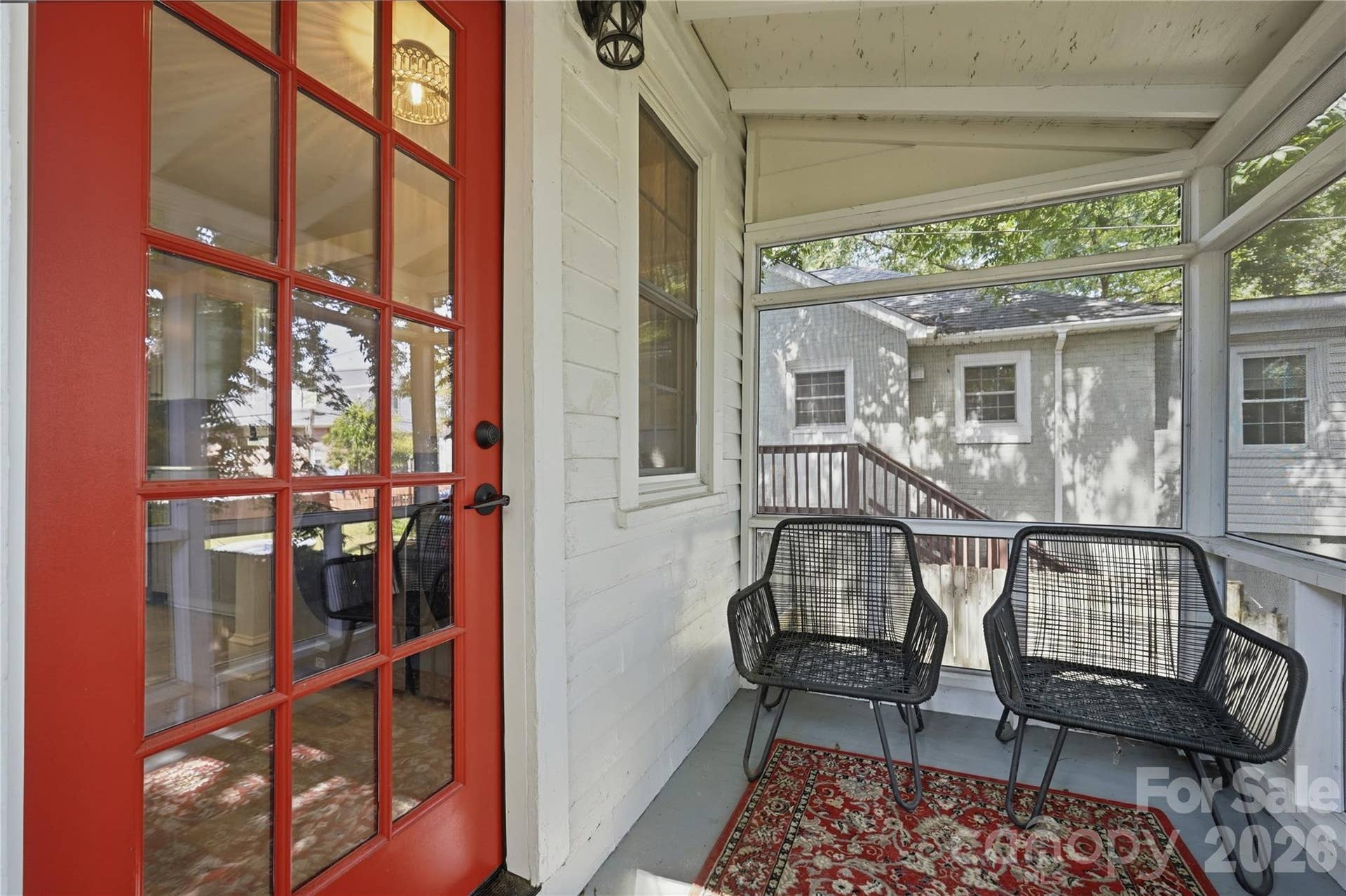 Comfortable seating and easy access make this screened porch a natural extension of the home's living space.