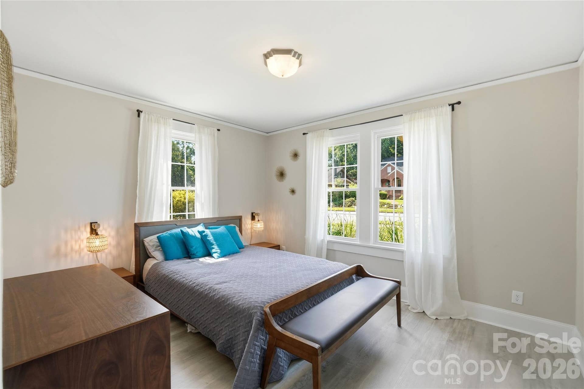This front bedroom is filled with natural light from two large windows, with a bright, airy feel throughout.