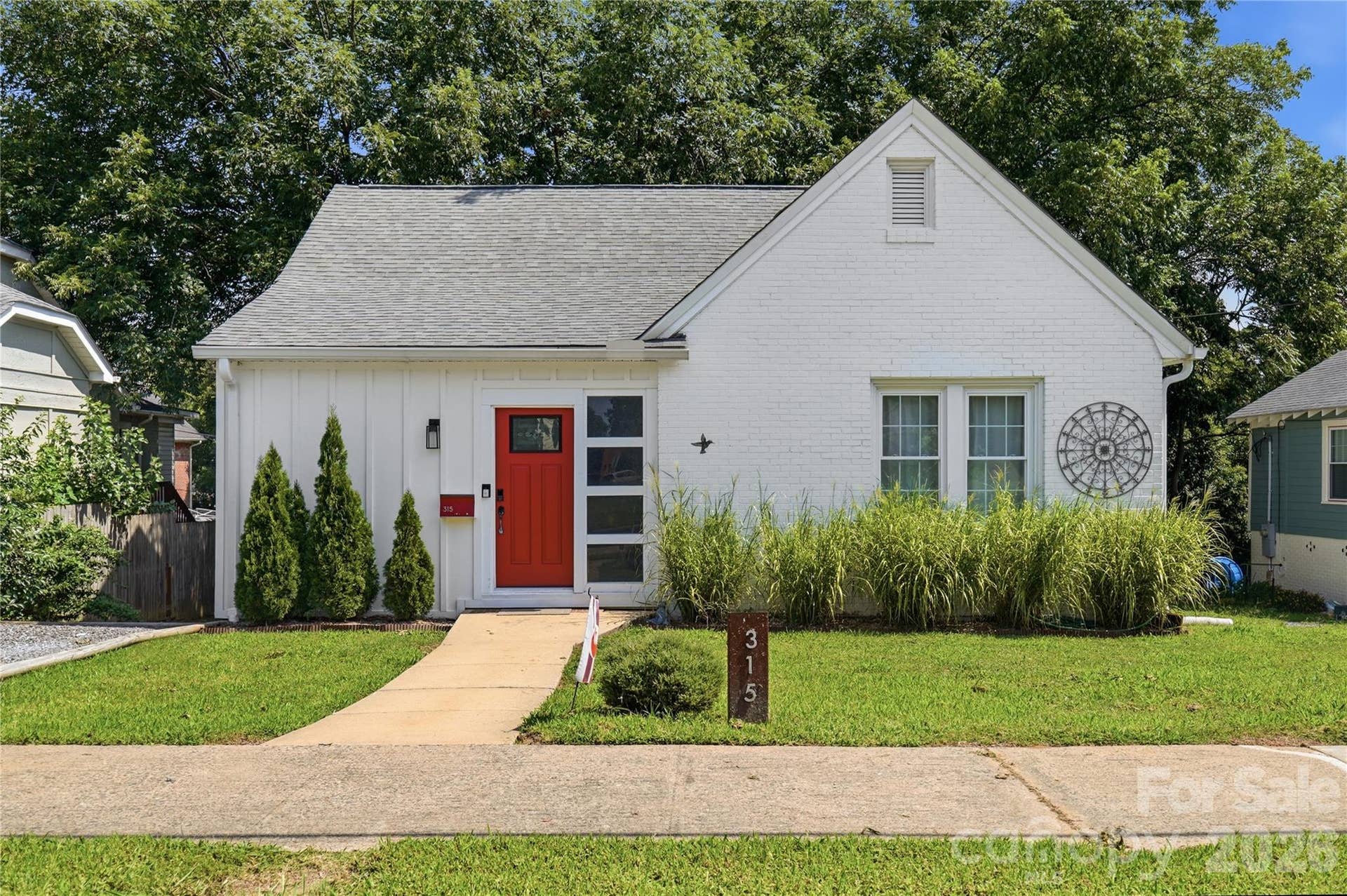 Board and batten siding and whitewashed brick give this Old Town Rock Hill home instant curb appeal.